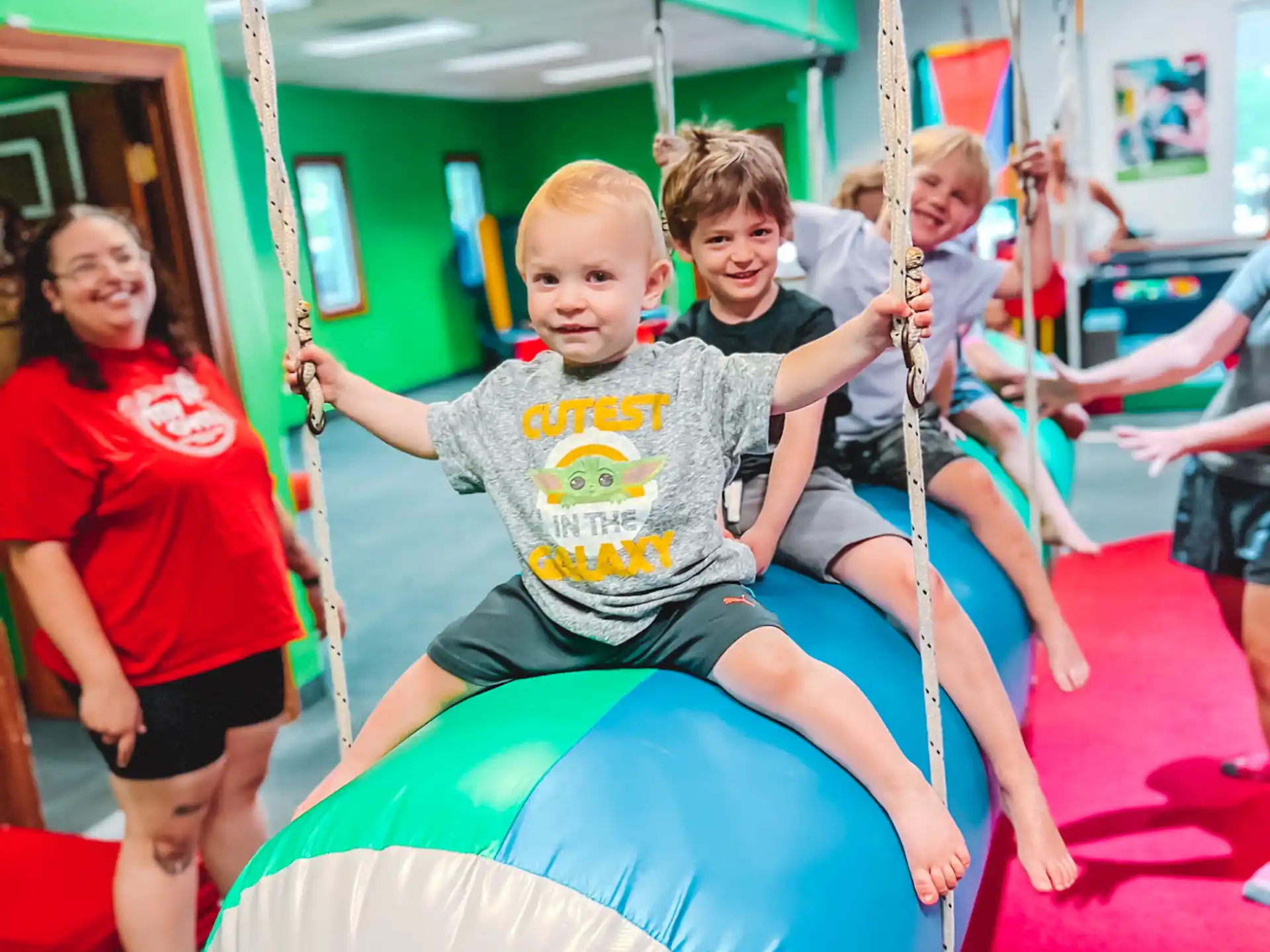 a group of kids on a swing