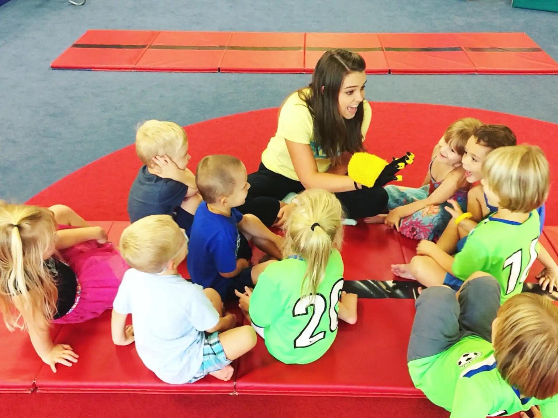 a person and several children sitting on the floor