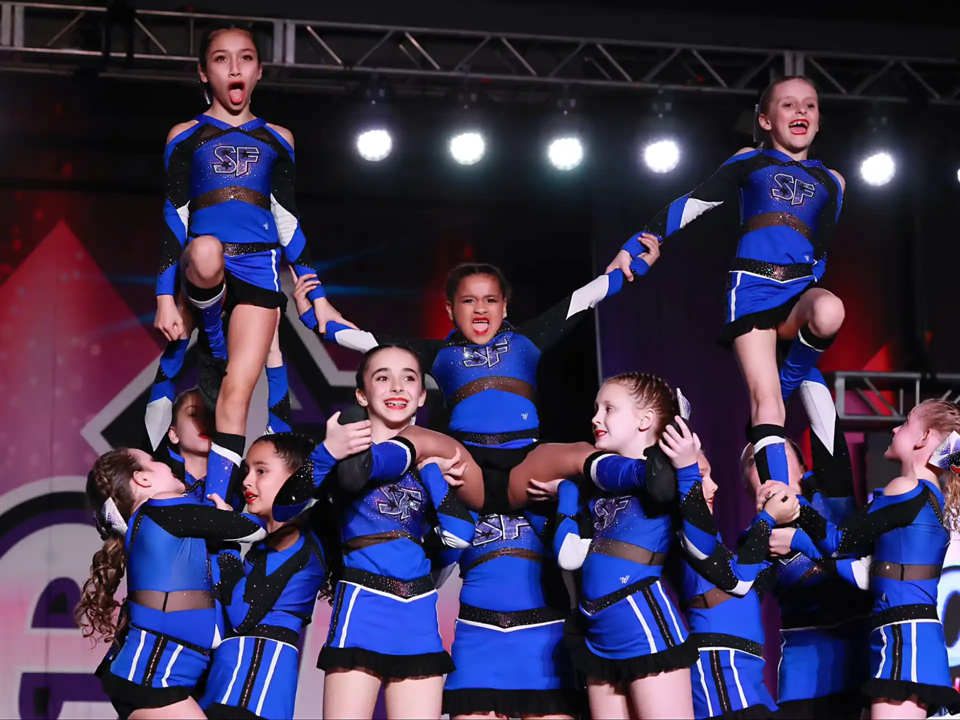 a group of cheerleaders posing for a photo