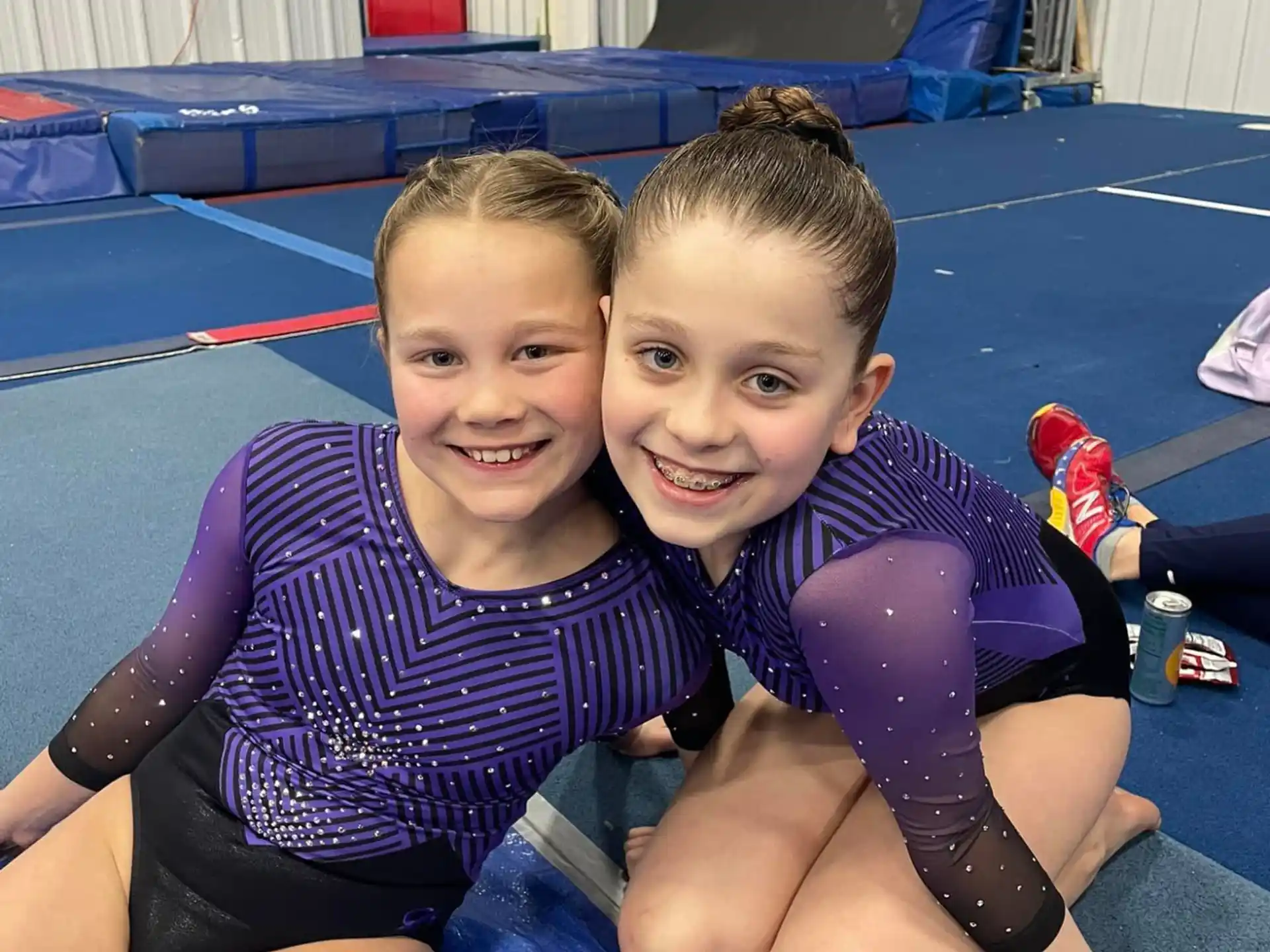 two children sitting on a mat