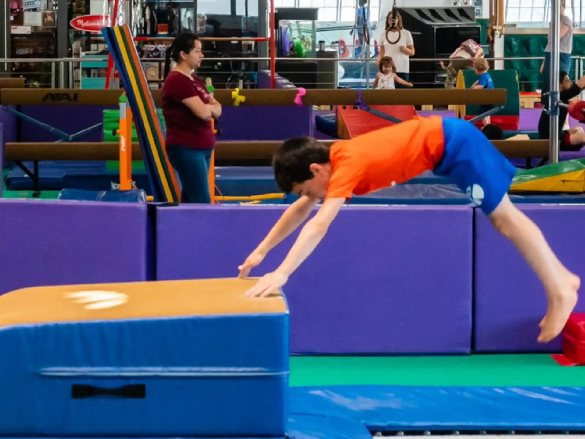 a person doing a plank on a mat in a gym
