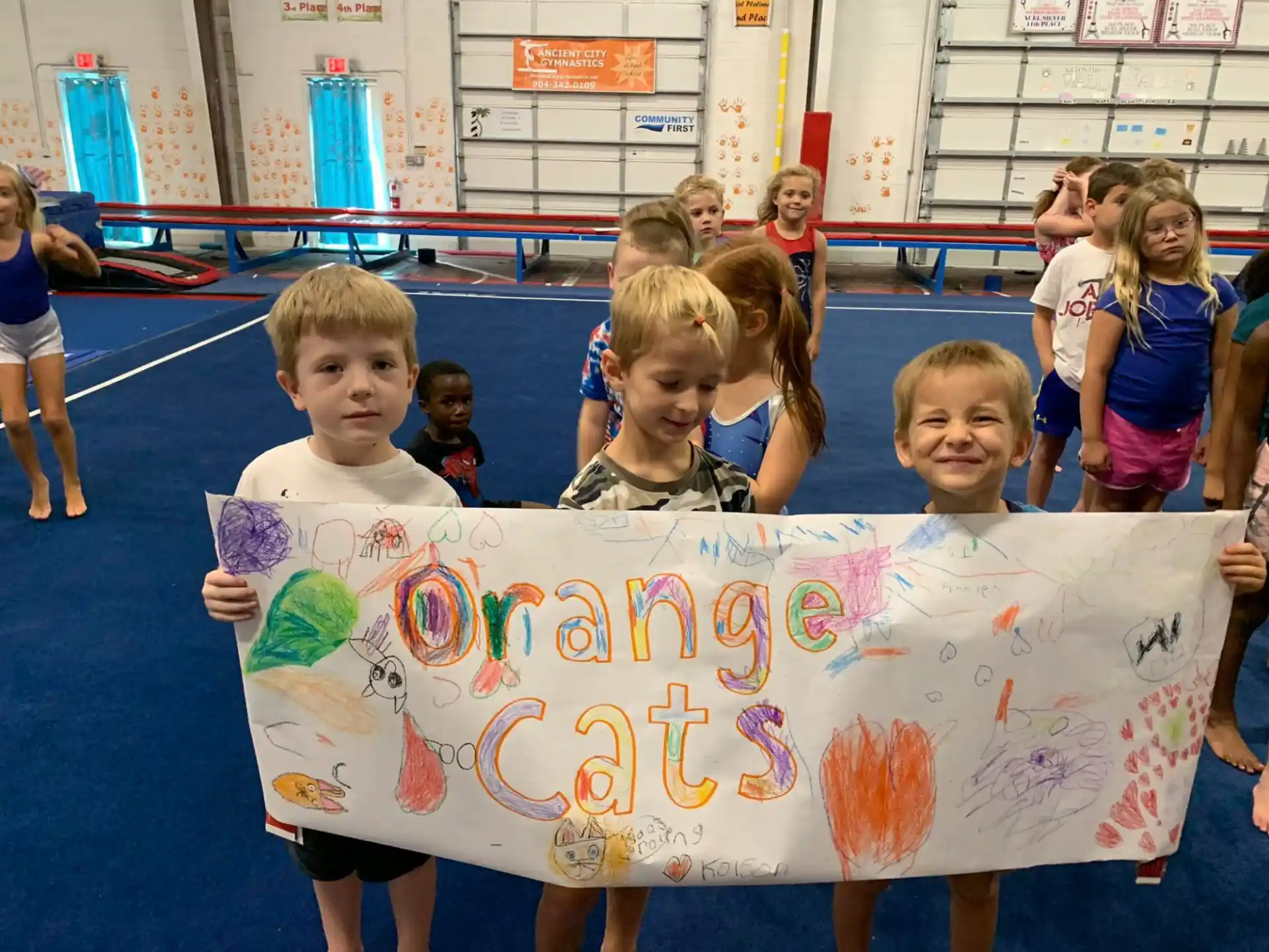 a group of children holding a banner