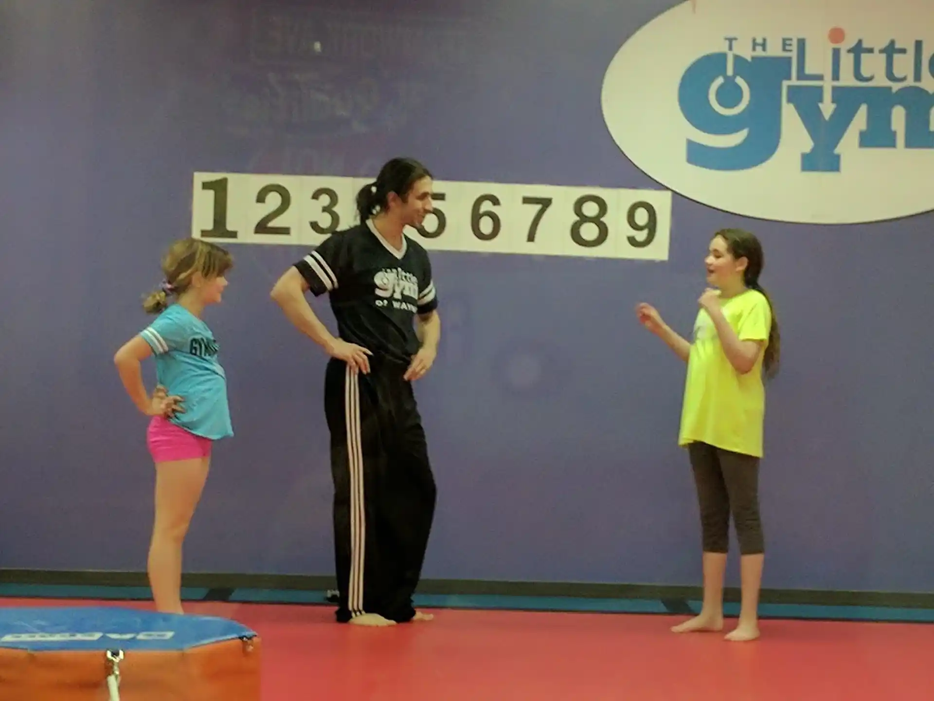 a woman and two girls on a stage