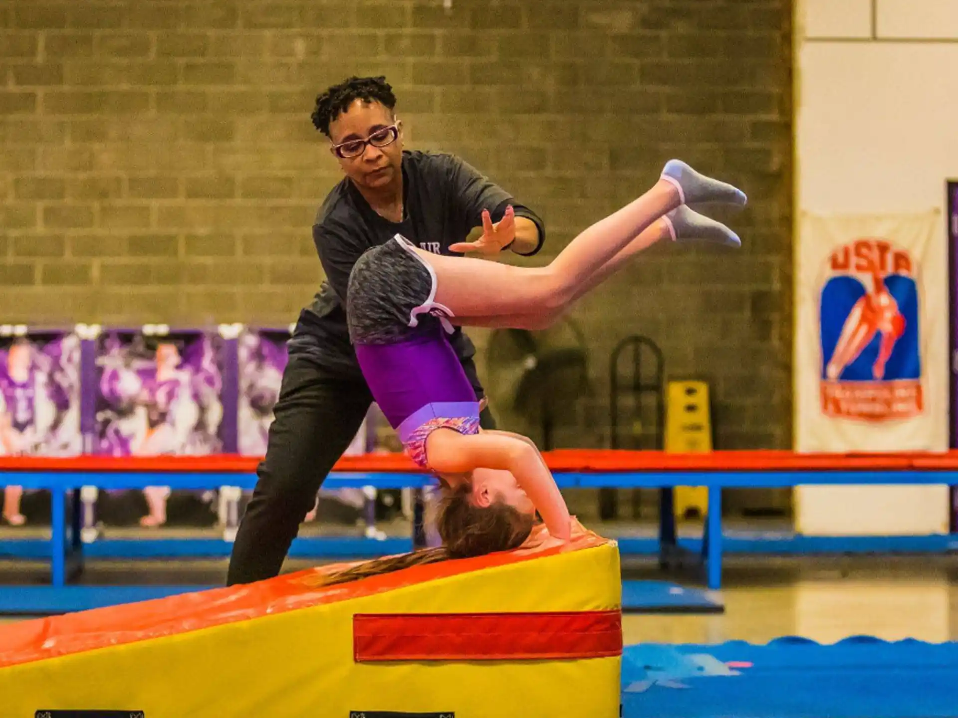 a man holding a woman in a gym