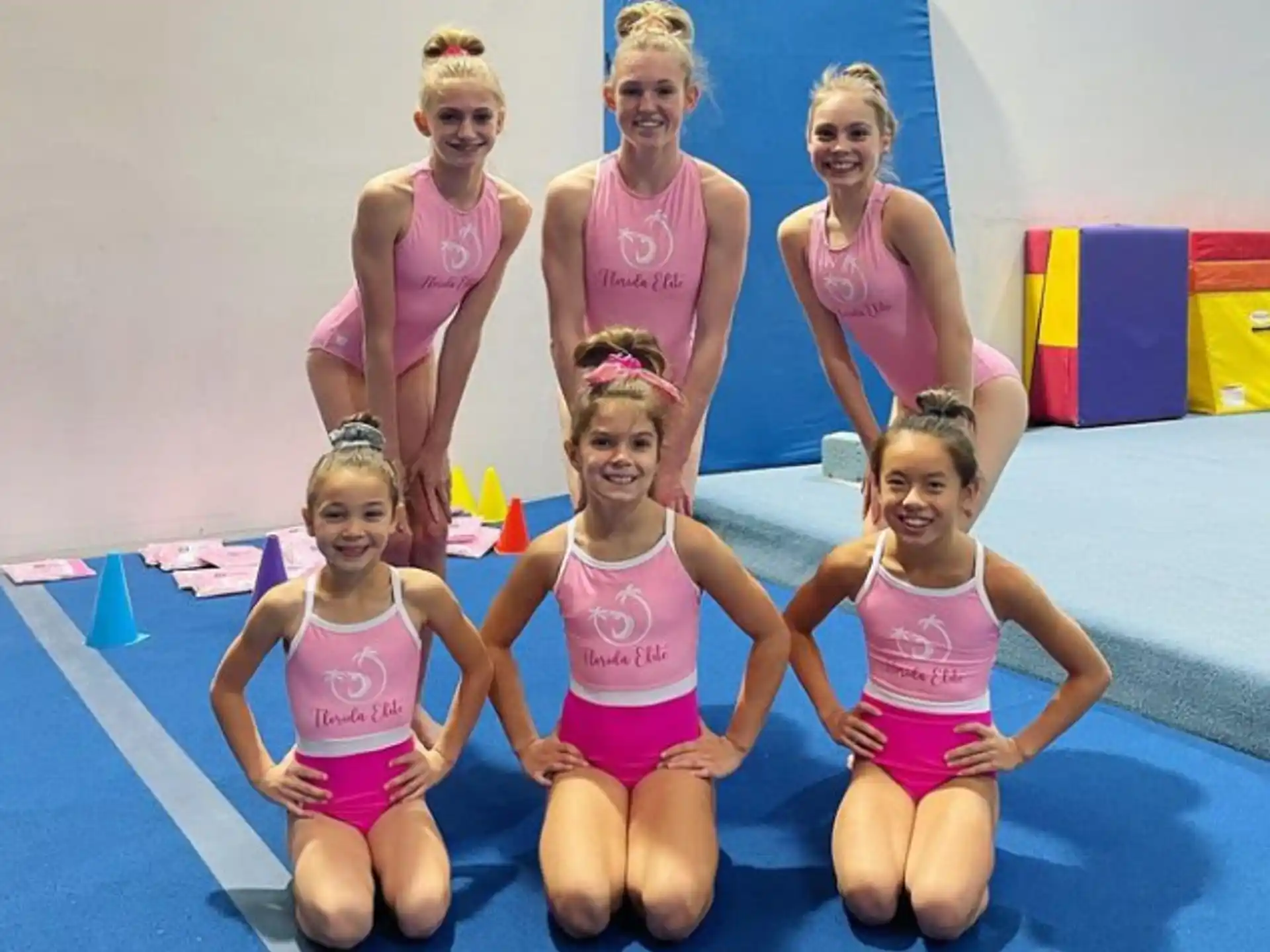 a group of girls in swimsuits posing for a photo