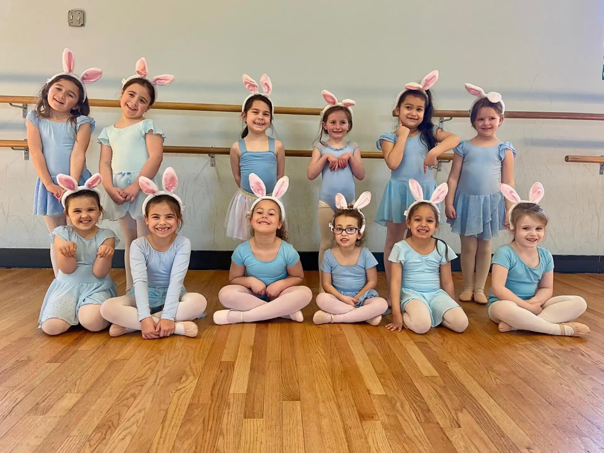 a group of girls in blue dresses