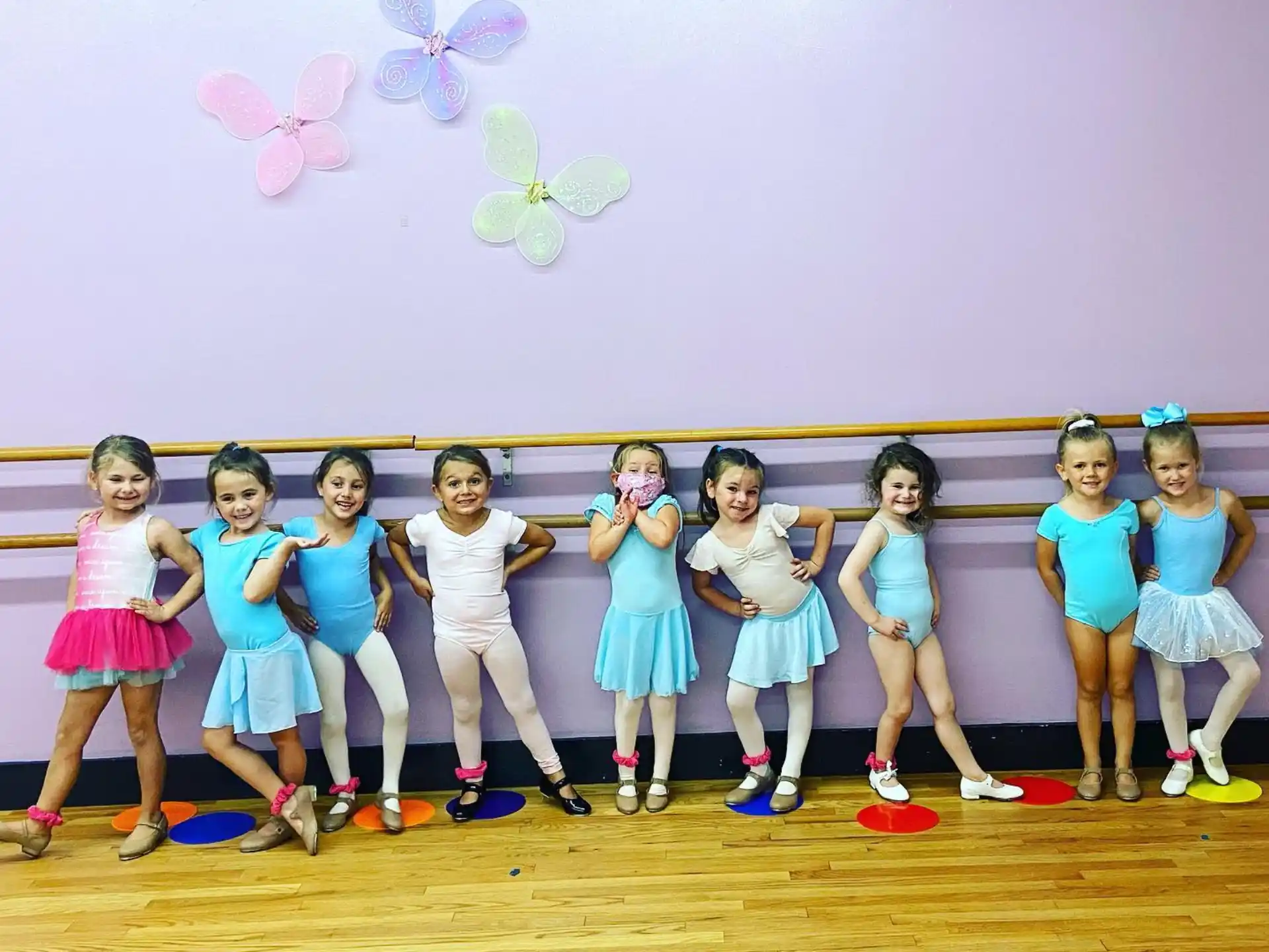 a group of girls in blue dresses