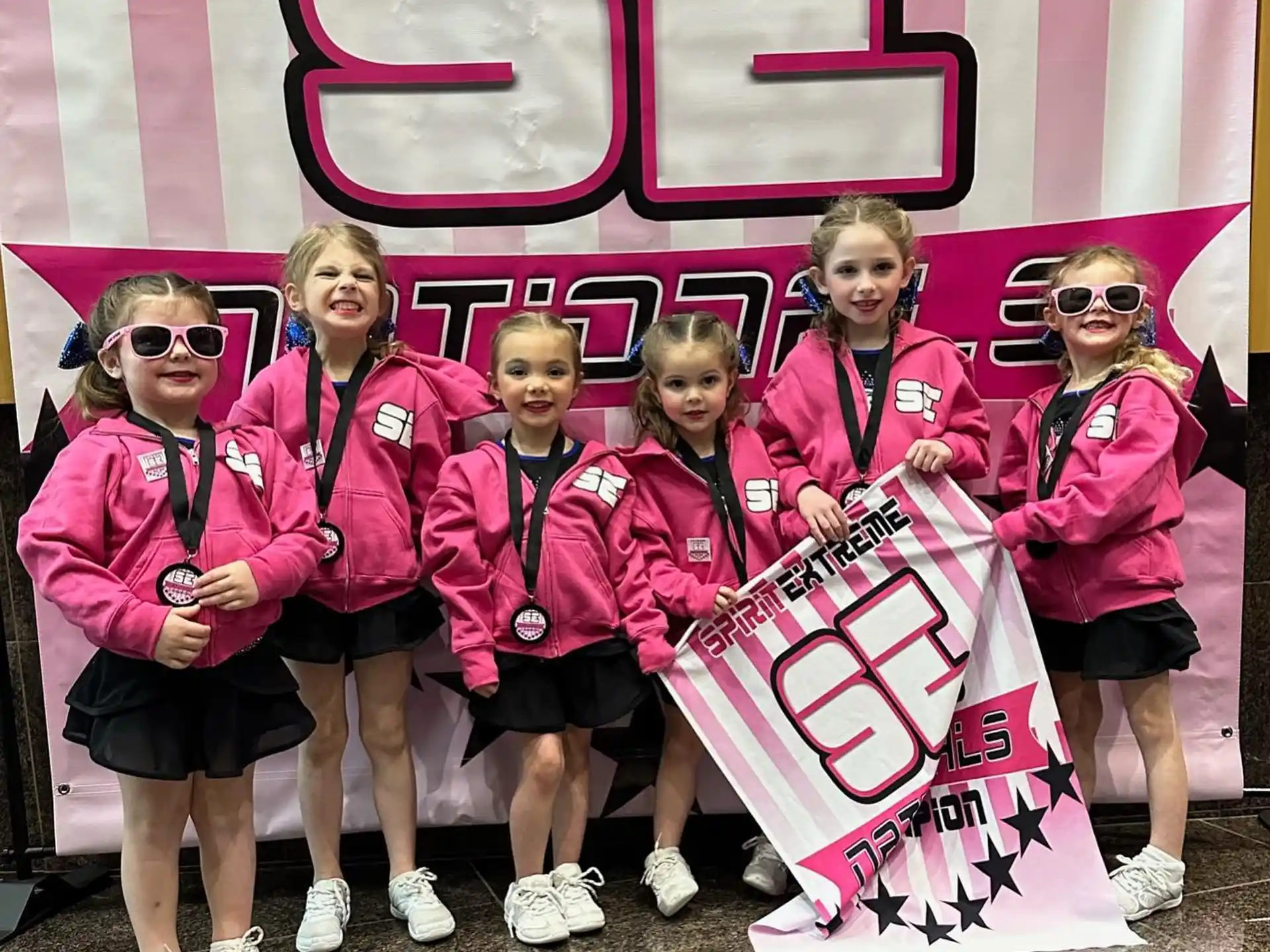 a group of women in pink jackets
