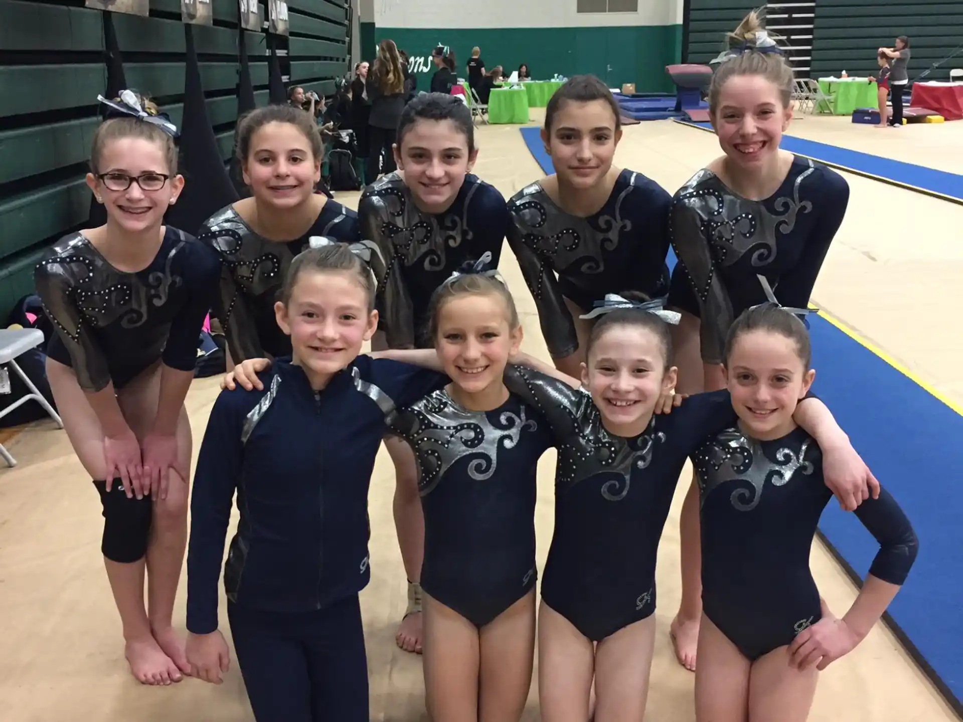 a group of people wearing leotards posing for the camera