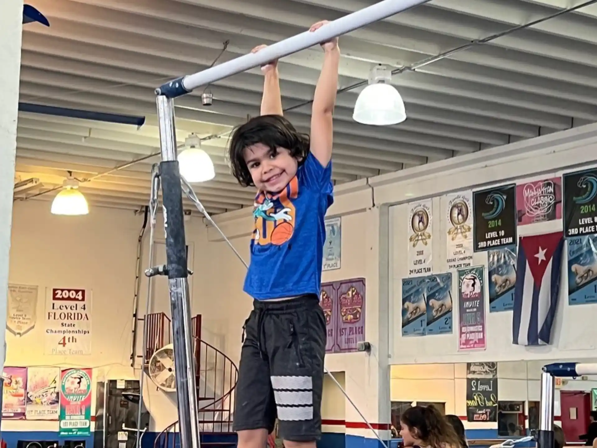a boy holding a barbell