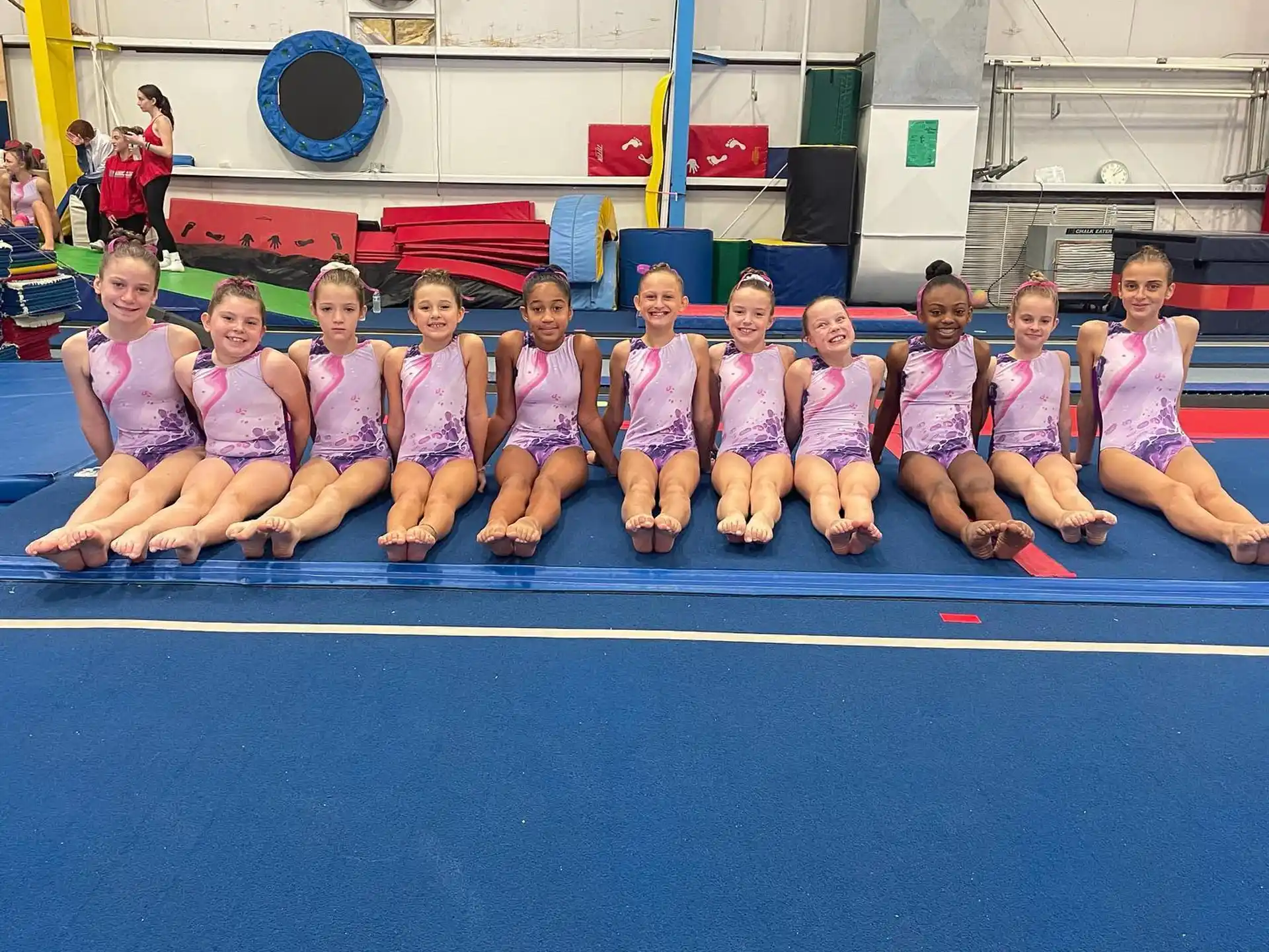 a group of girls in pink shirts