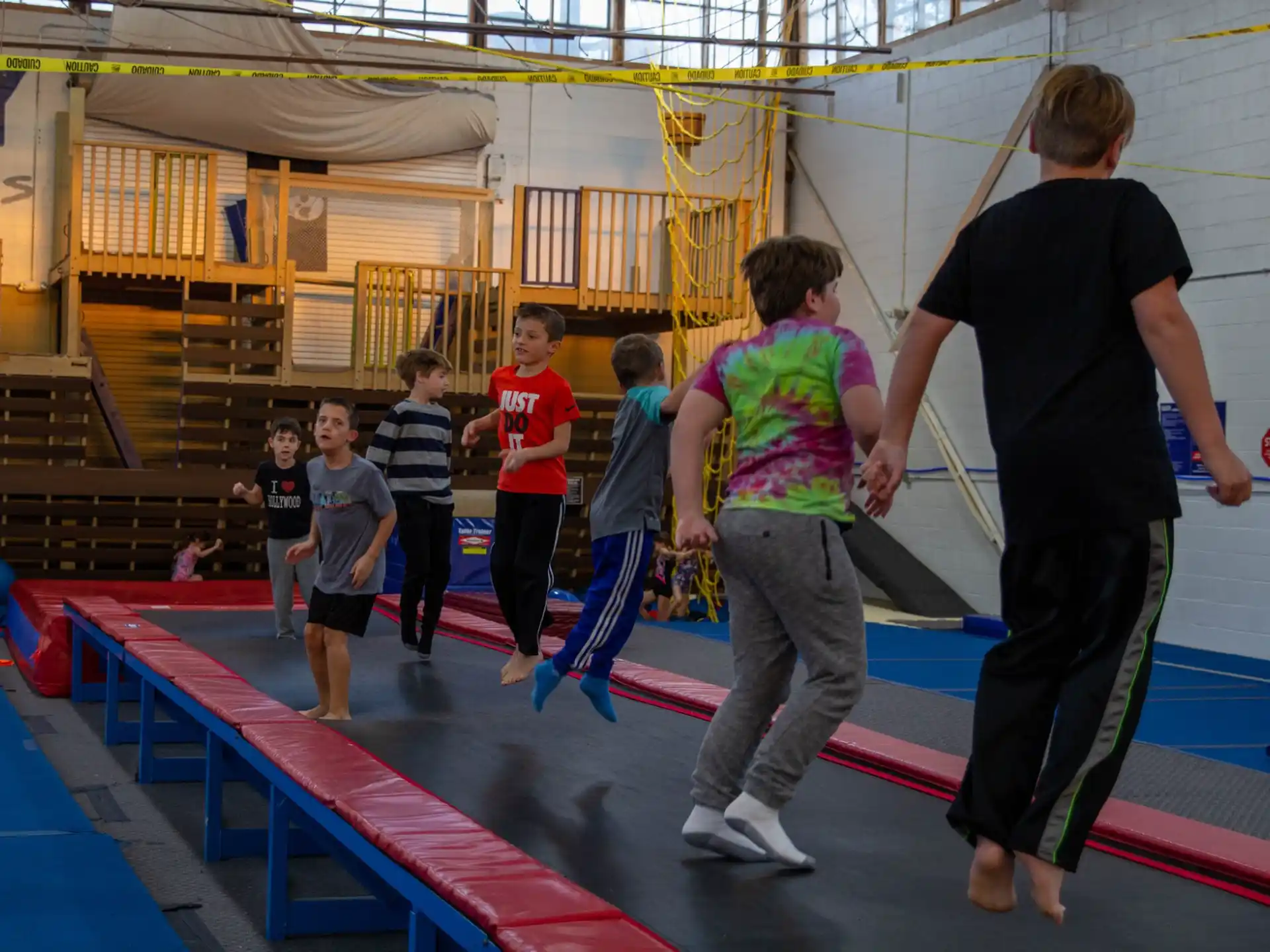 a group of kids playing on a mat in a gym