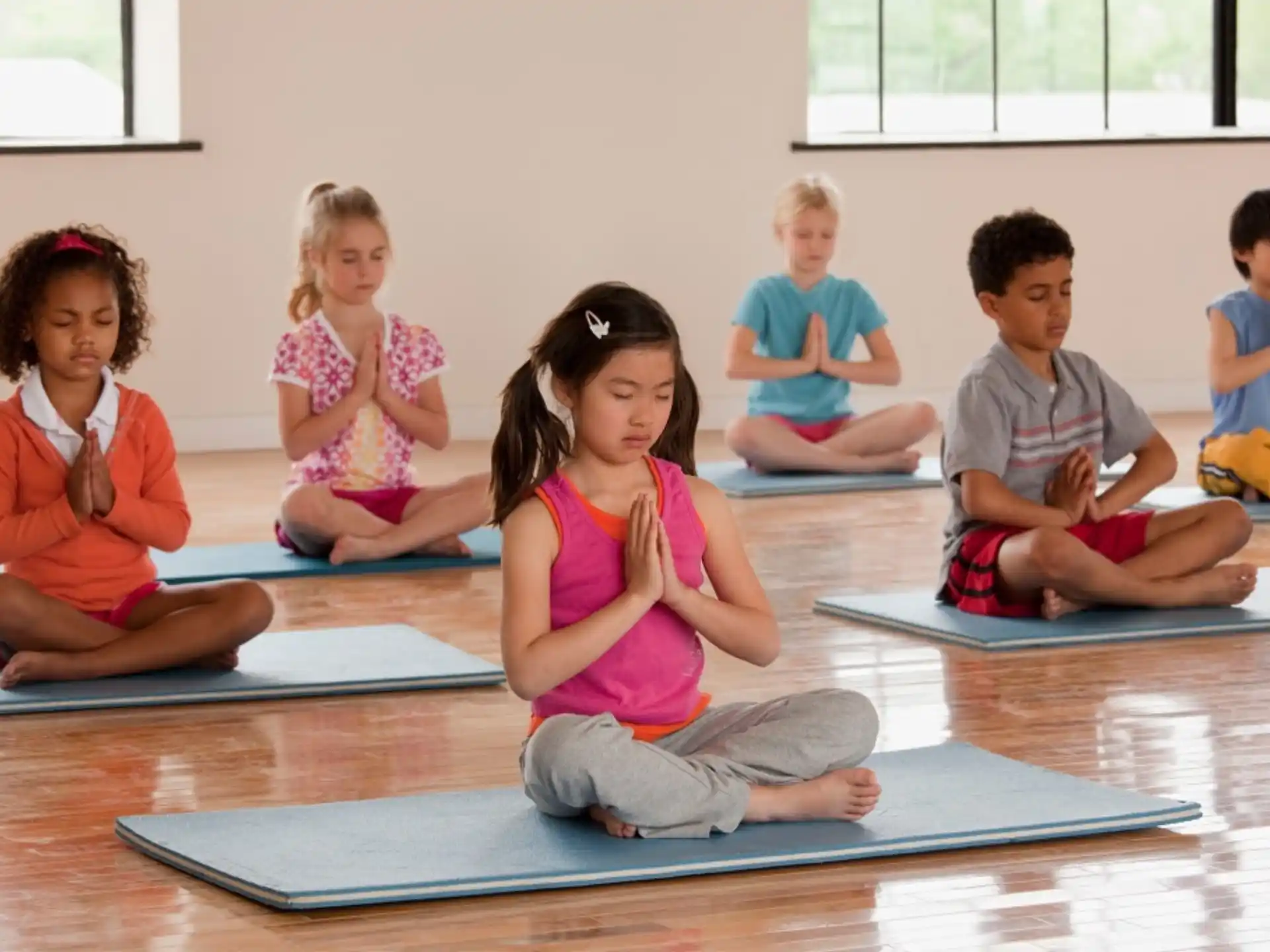 a group of children sitting on mats