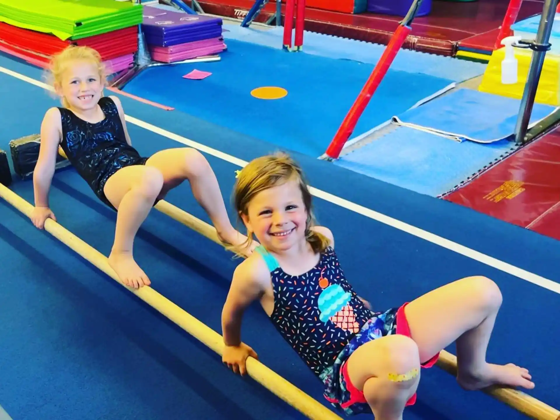 two girls in swimsuits on a trampoline