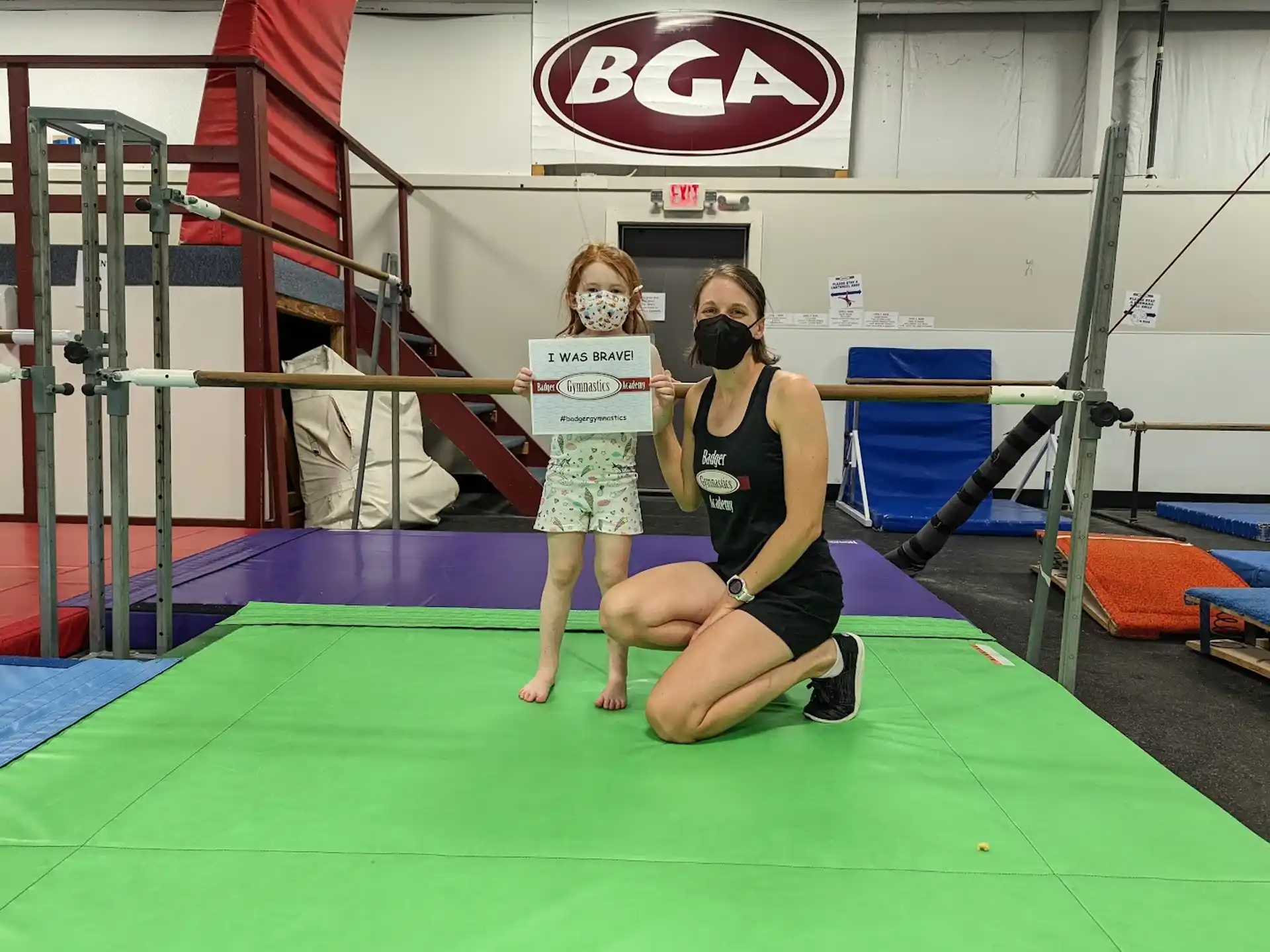 a person sitting on a mat with a person standing behind the