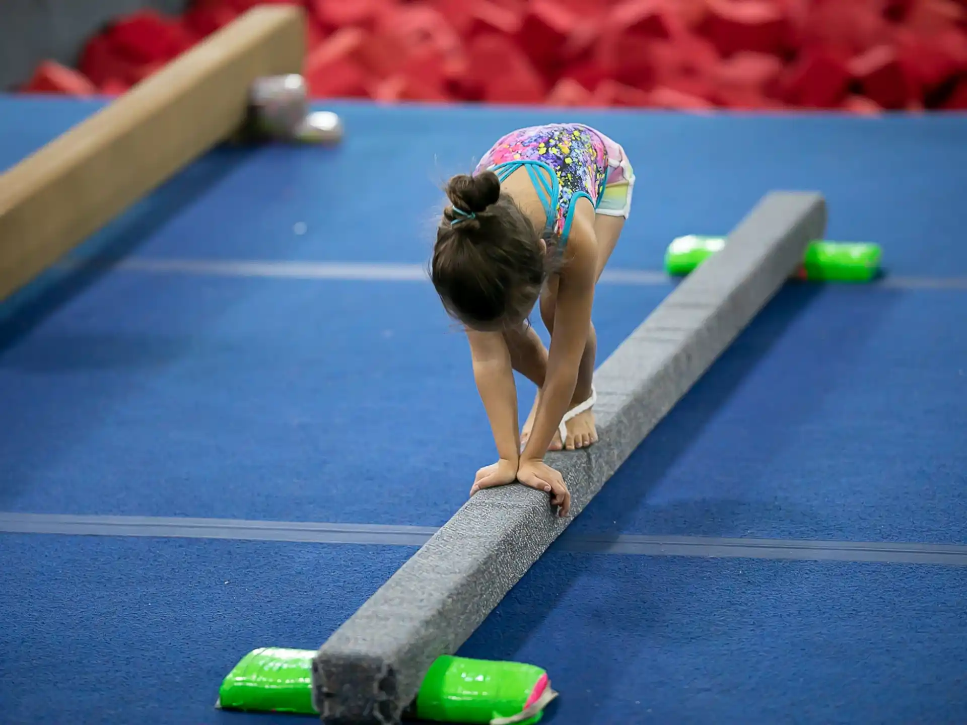 a person bending over to pick up a ball