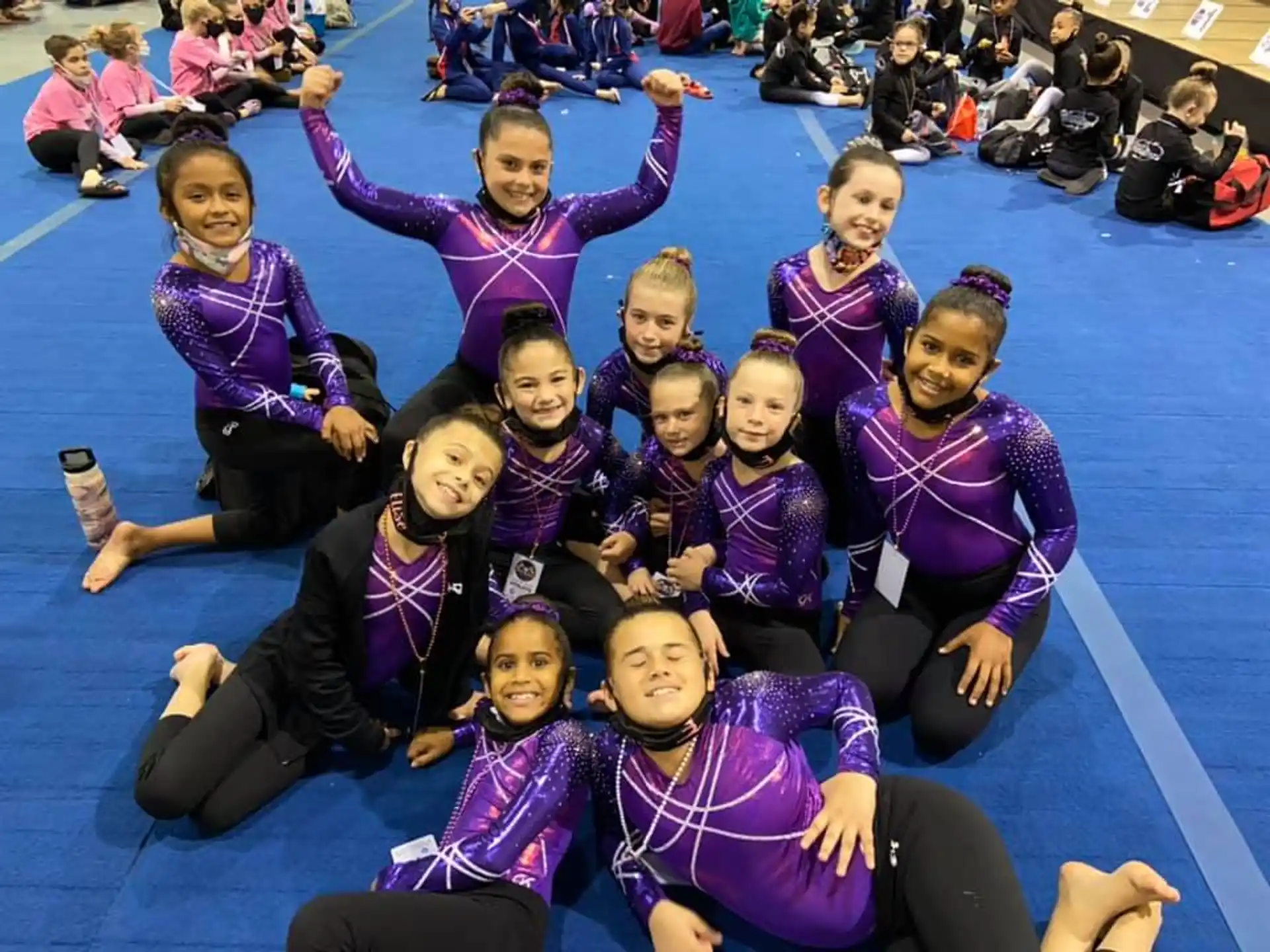a group of girls in purple shirts