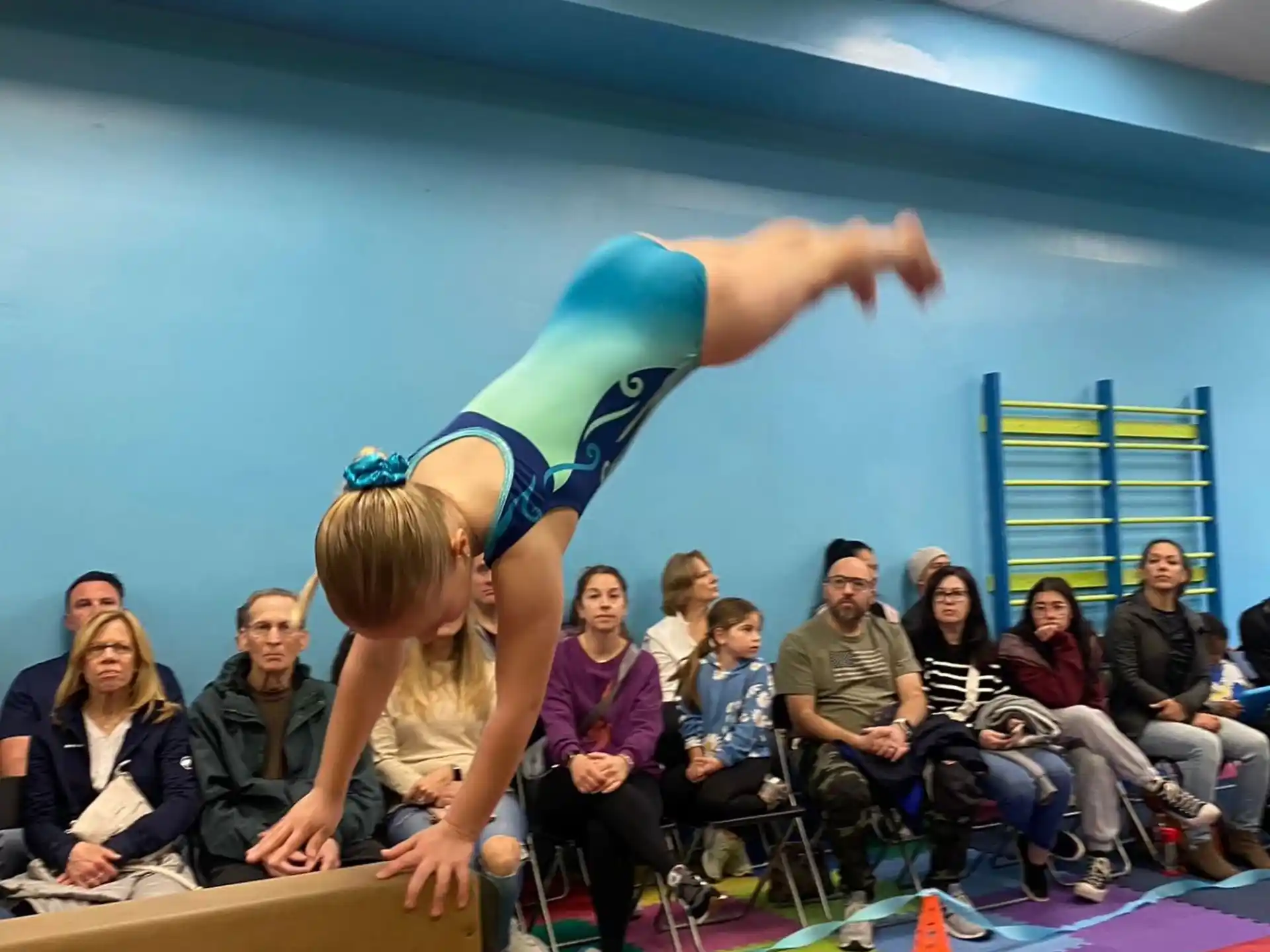 a person doing a handstand in front of a crowd of people
