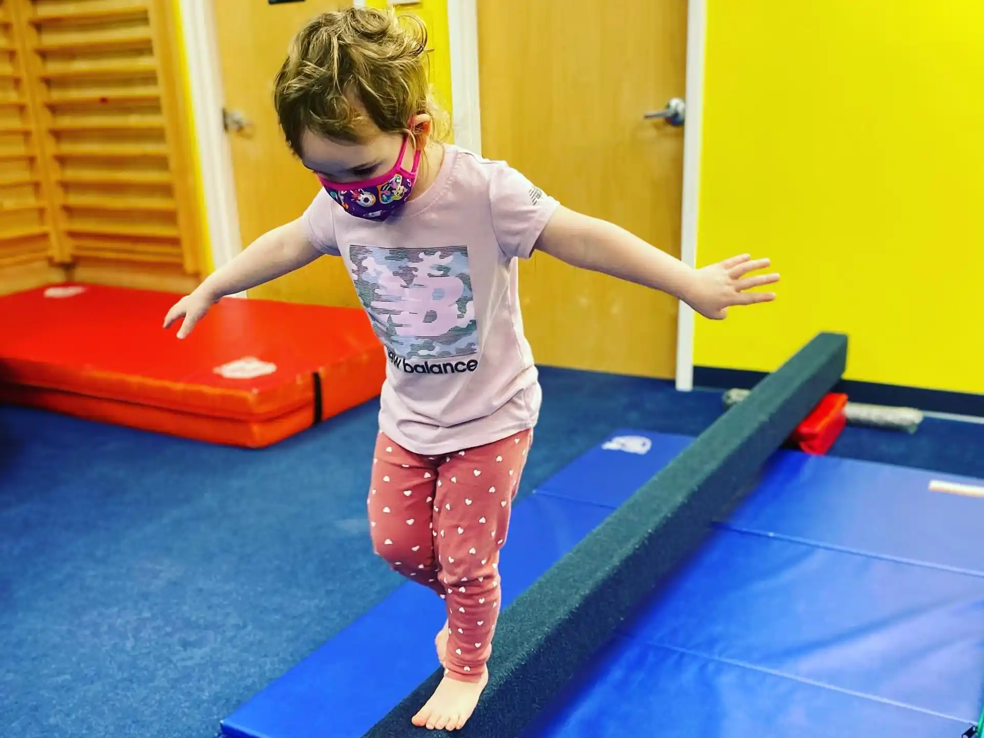 a child standing on a mat