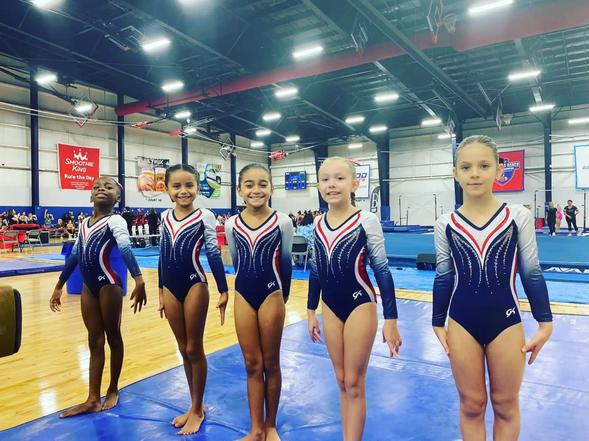 a group of women in leotards posing for a photo