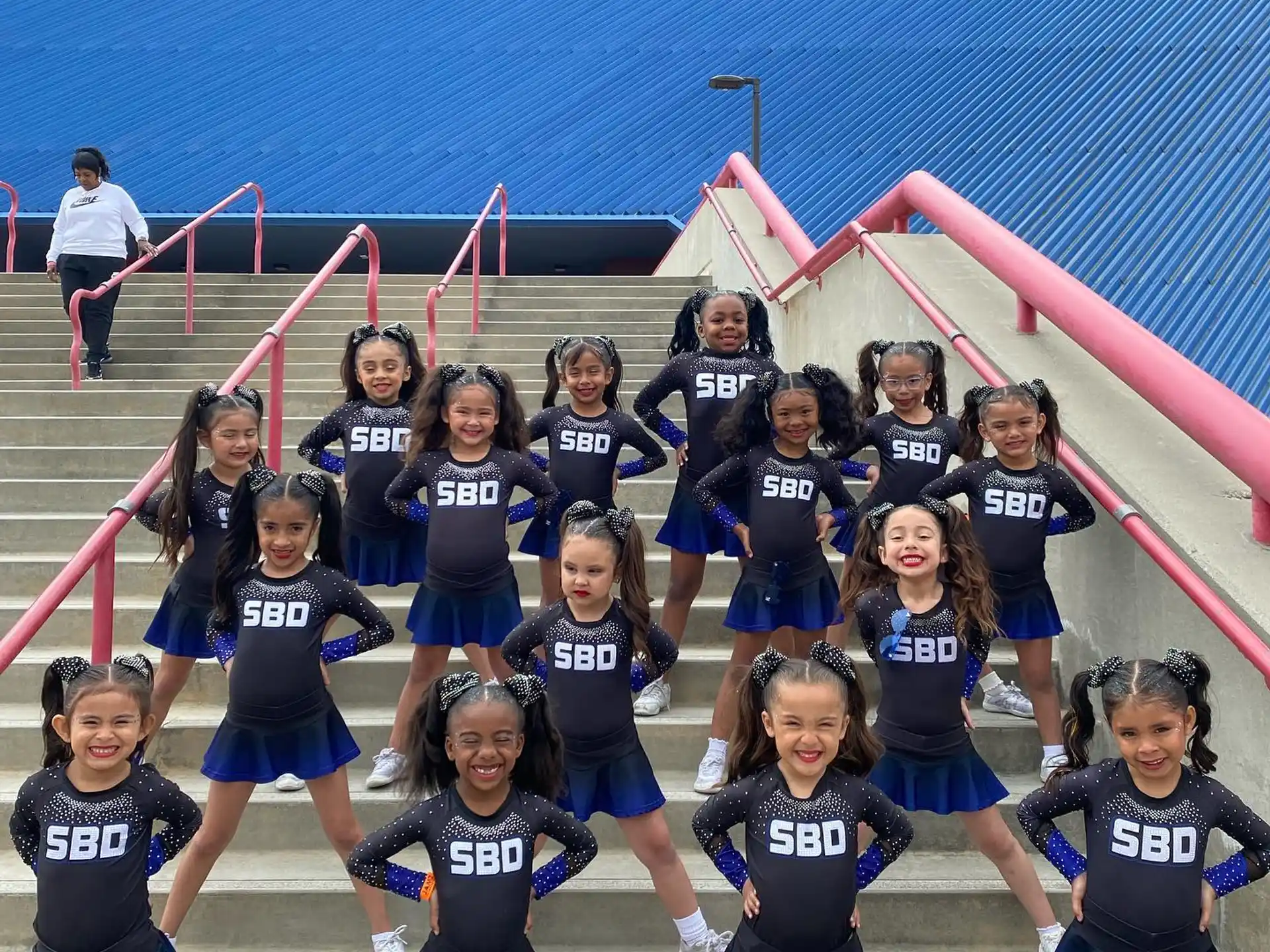 a group of girls posing for a photo on a track