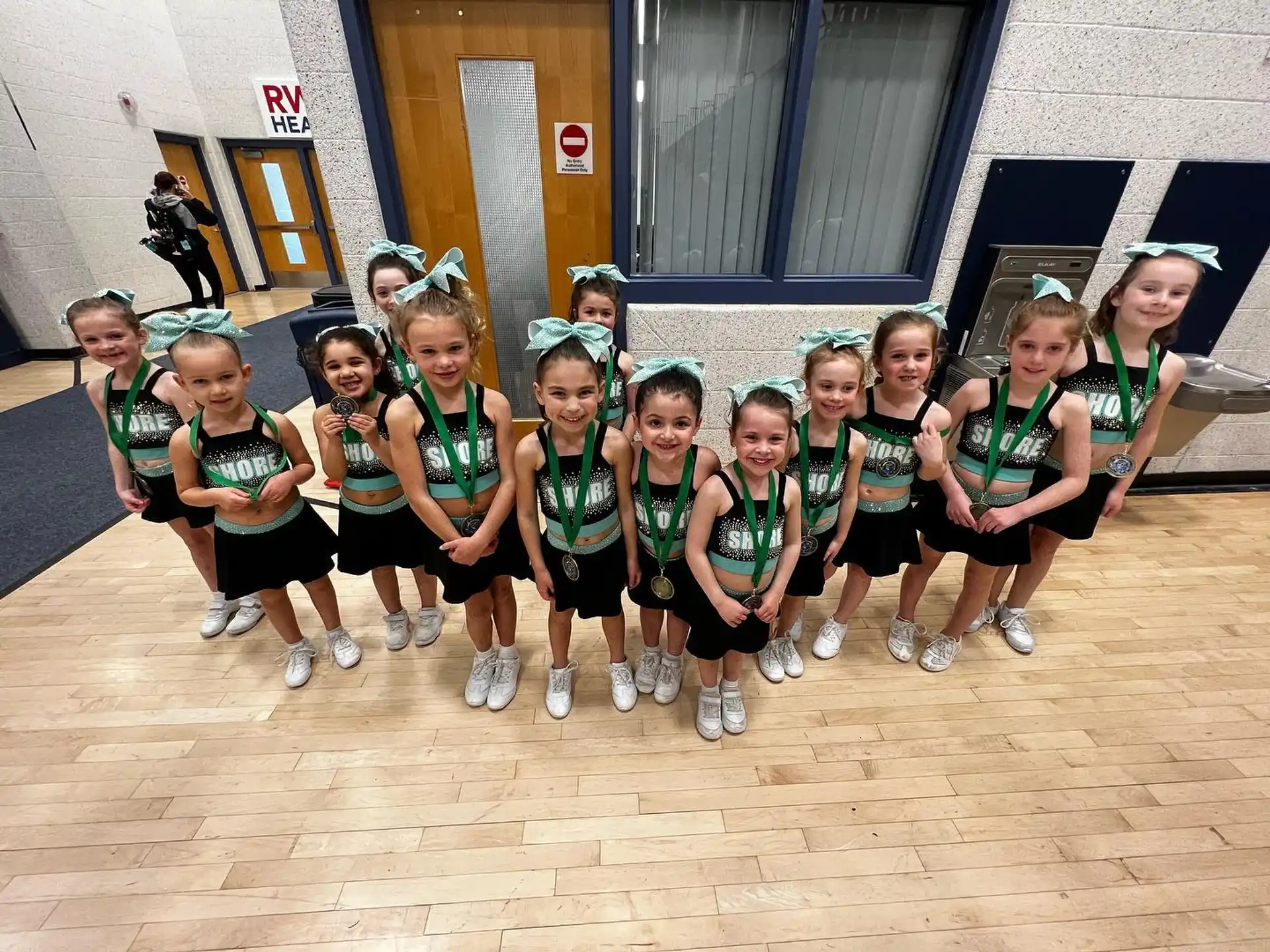 a group of girls in matching outfits