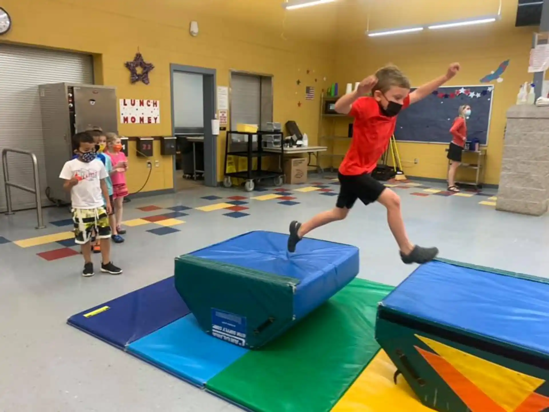 a group of kids playing on mats