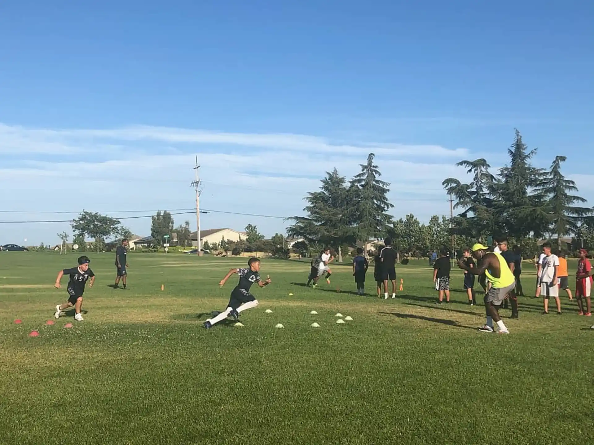 a group of people playing frisbee in a field