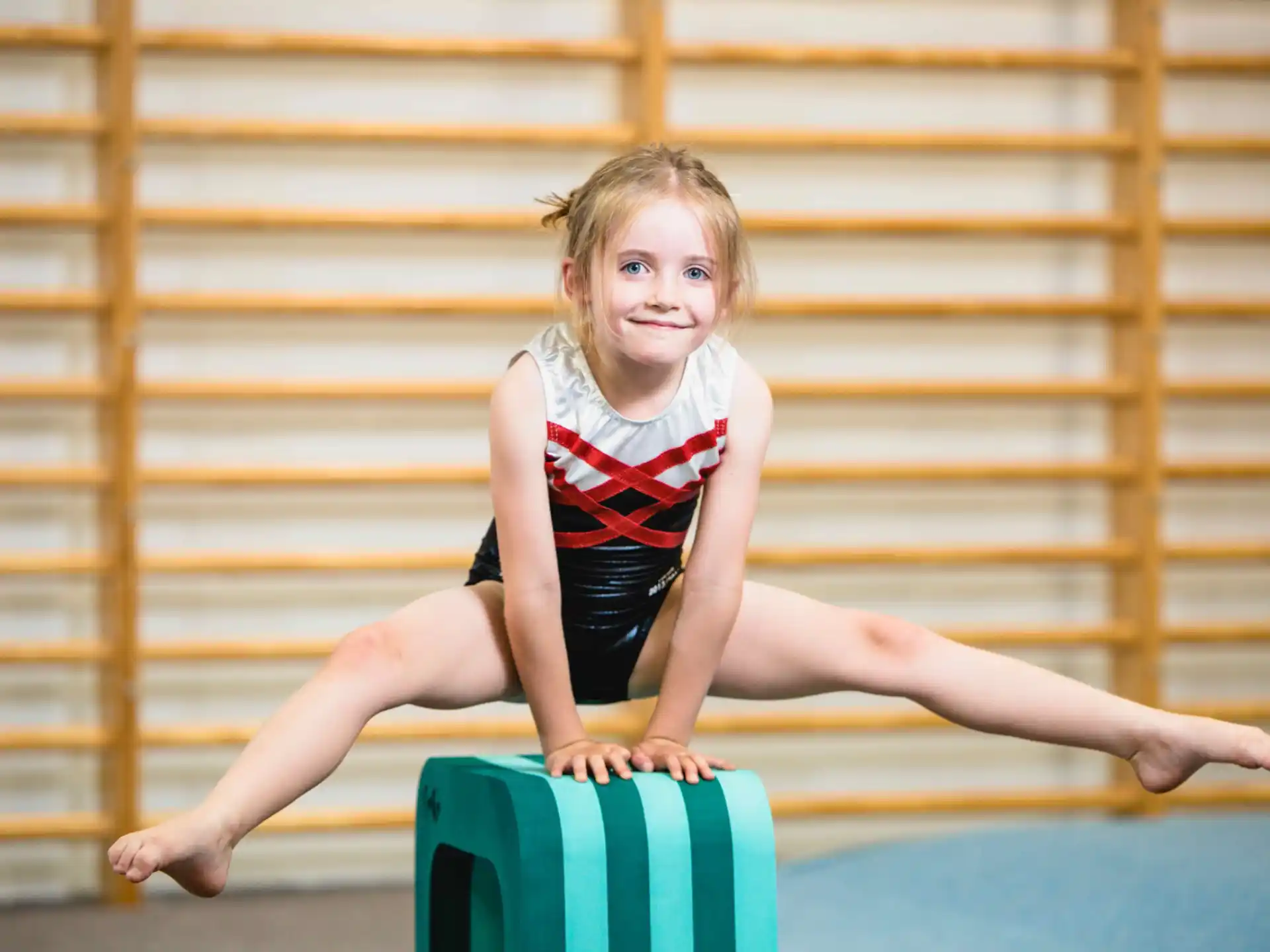 a girl sitting on a suitcase