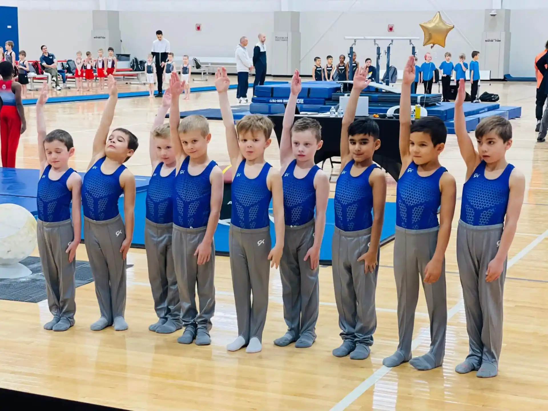 a group of children in blue shirts