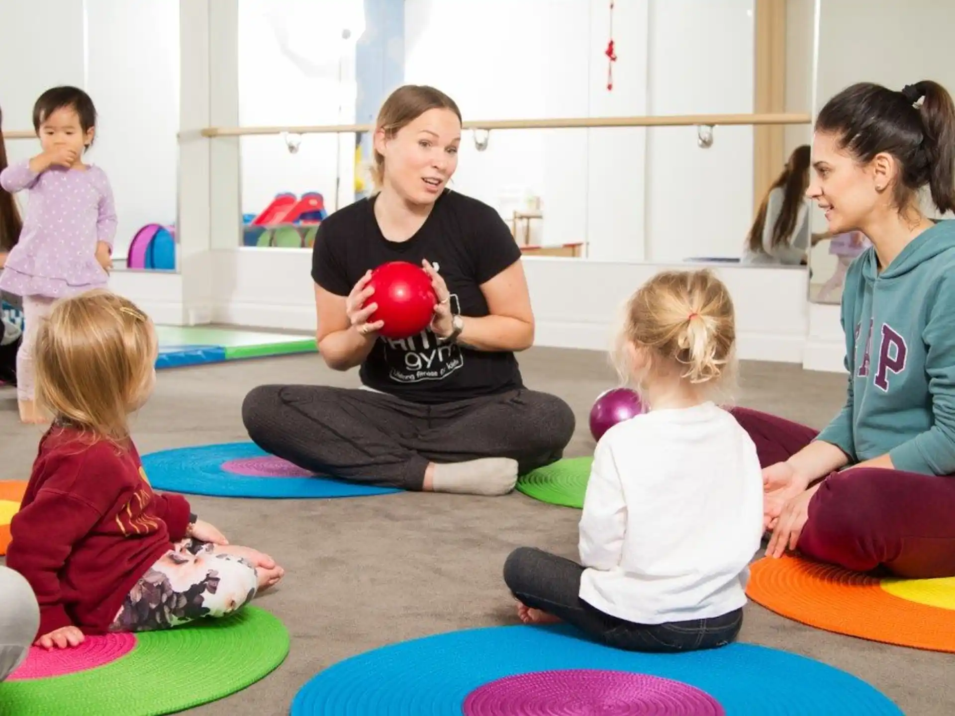 a person and several children sitting on the floor