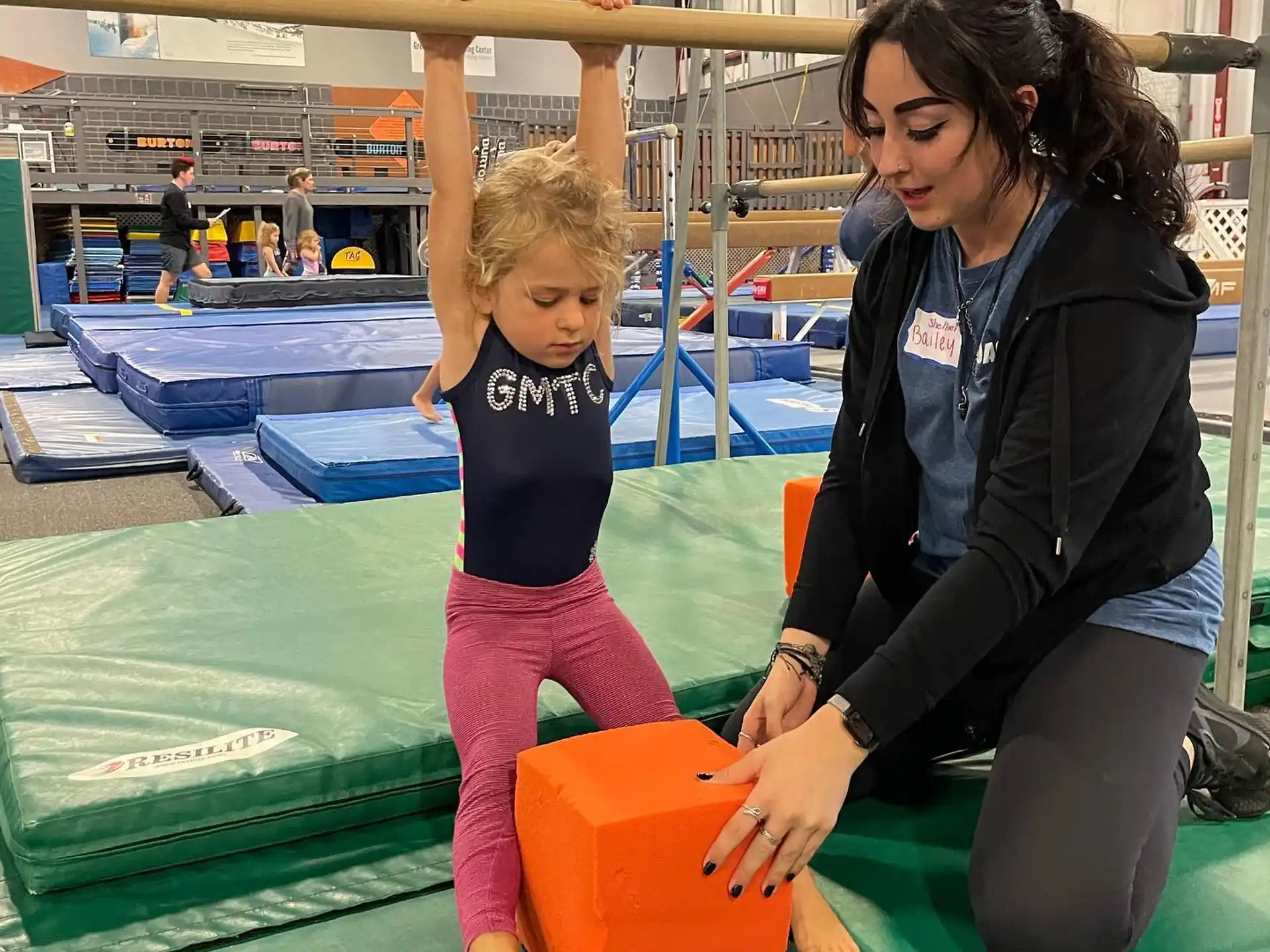 a person and a child playing on a trampoline