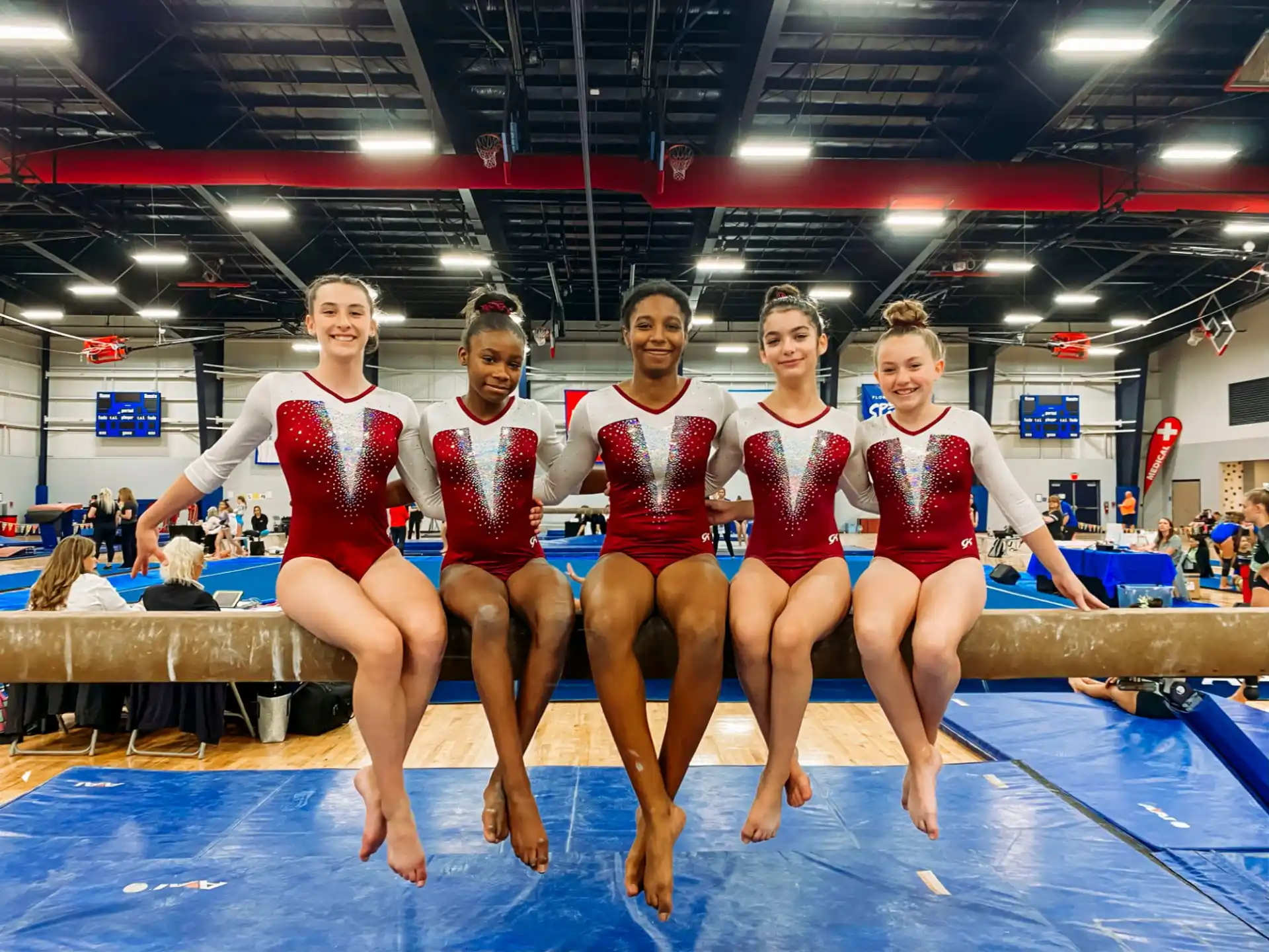 a group of women in red and white uniforms posing for a photo