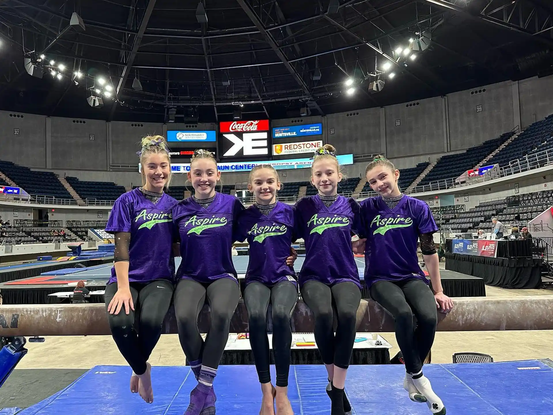 a group of people wearing purple shirts