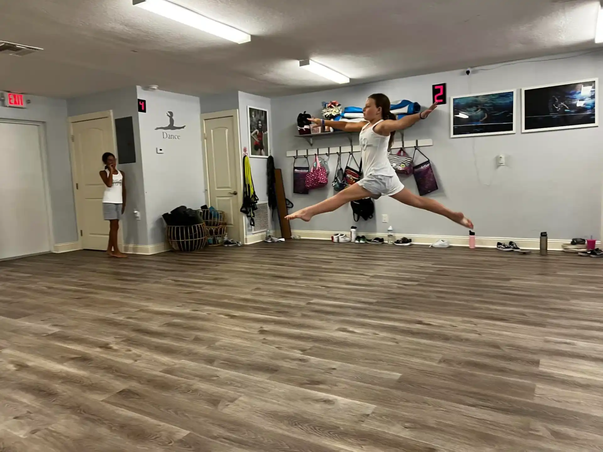 a man doing a handstand on a wood floor in a room