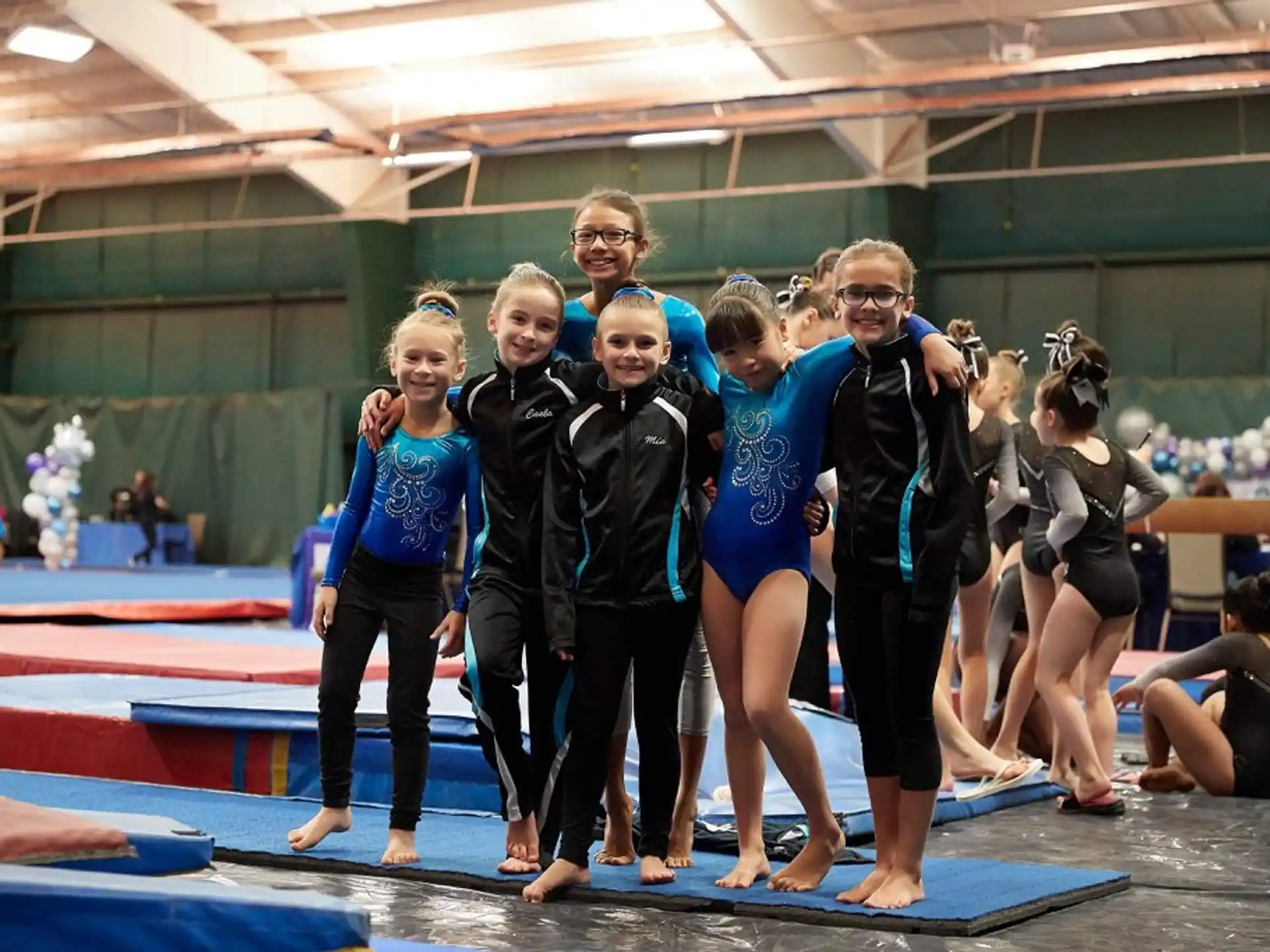 a group of women in leotards posing for a photo