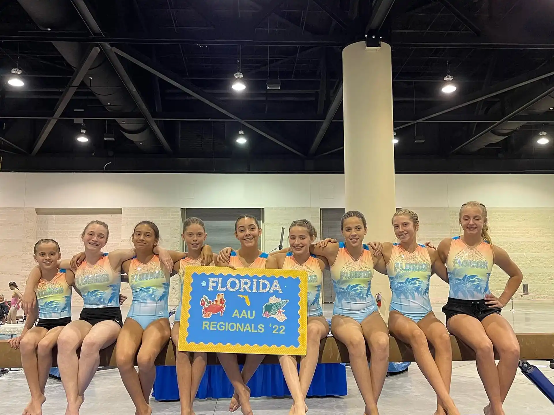 a group of women in swimsuits posing for a photo