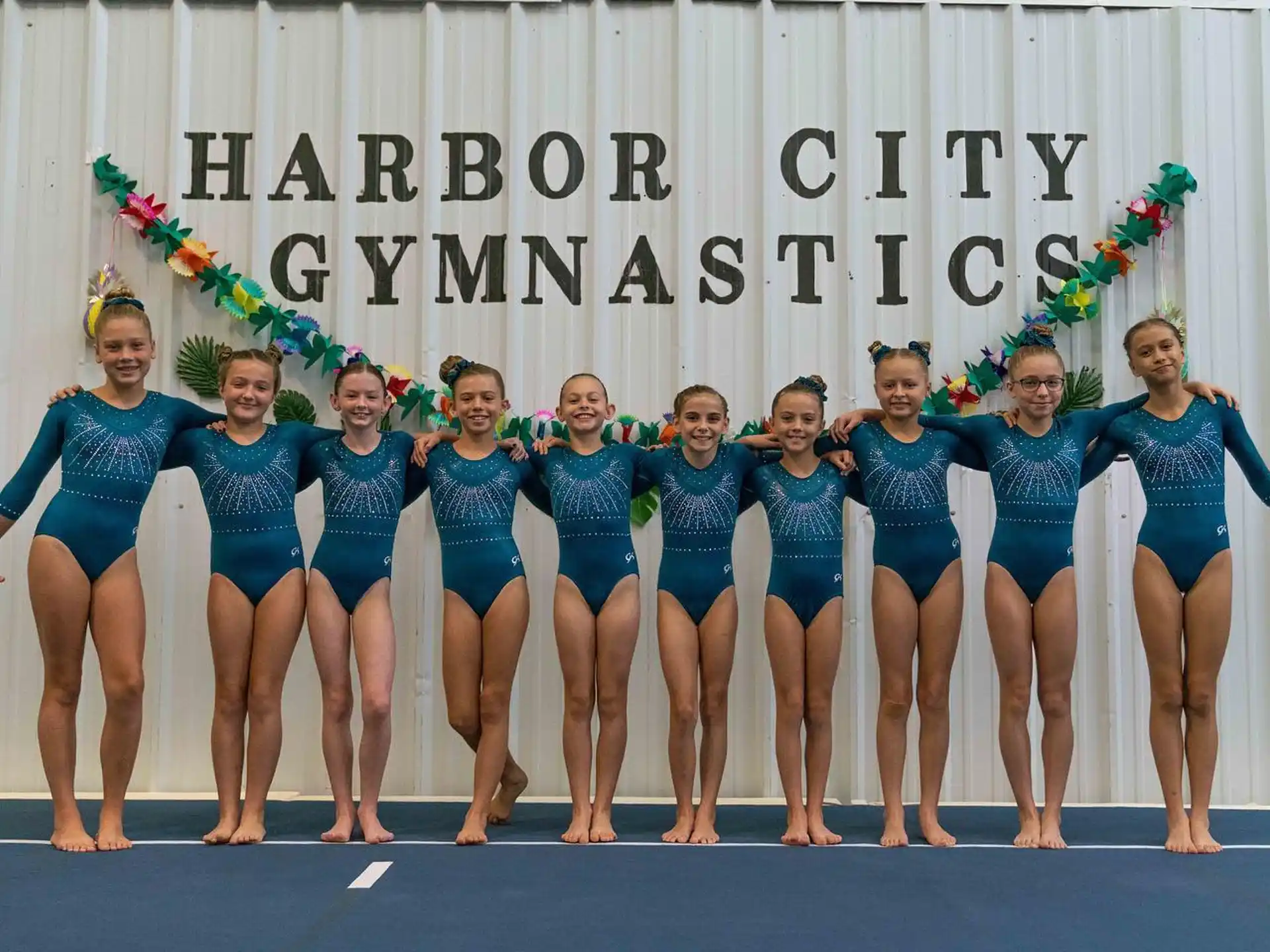 a group of women in swimsuits posing for a photo