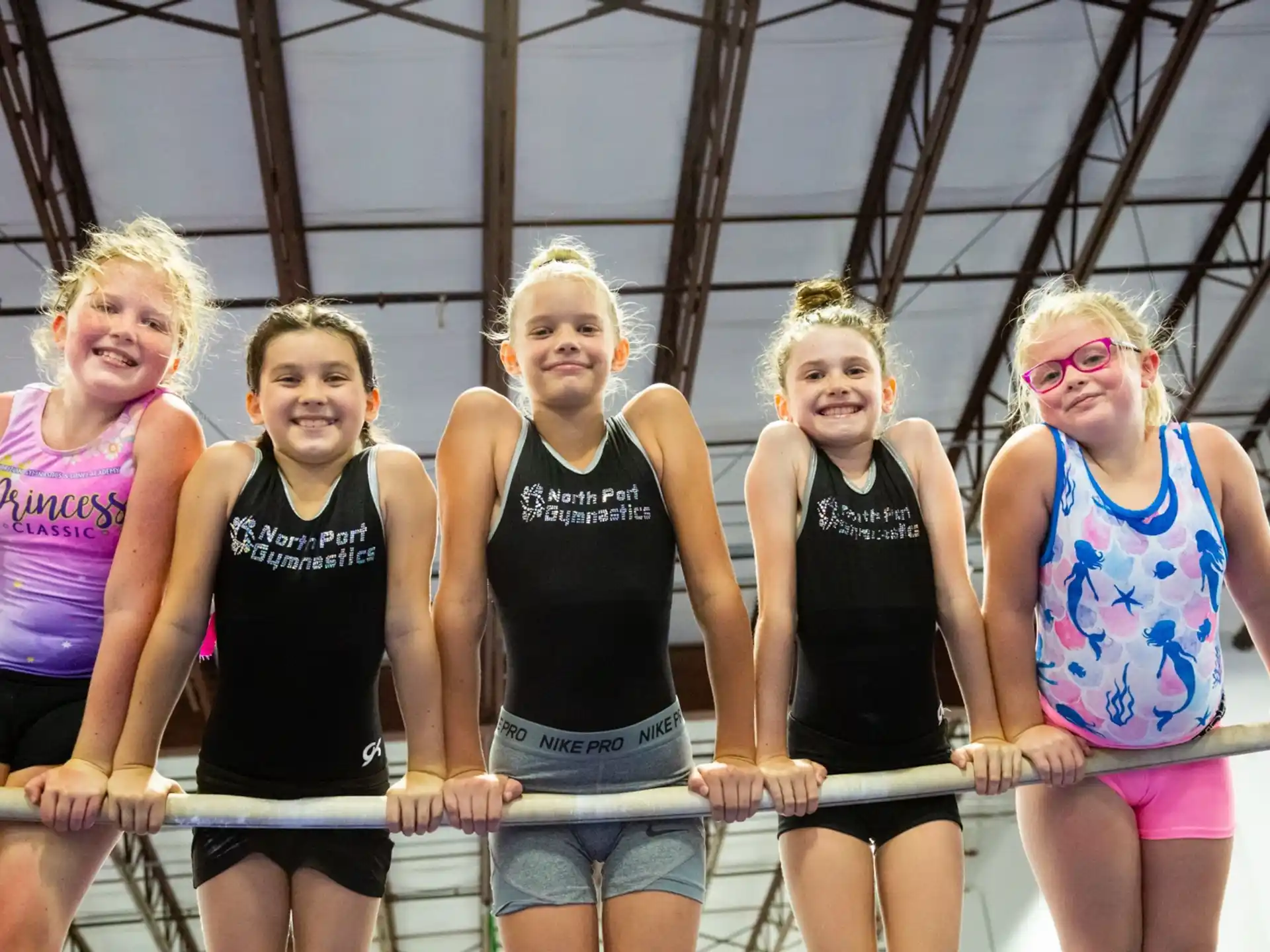 a group of women in swimsuits posing for a photo