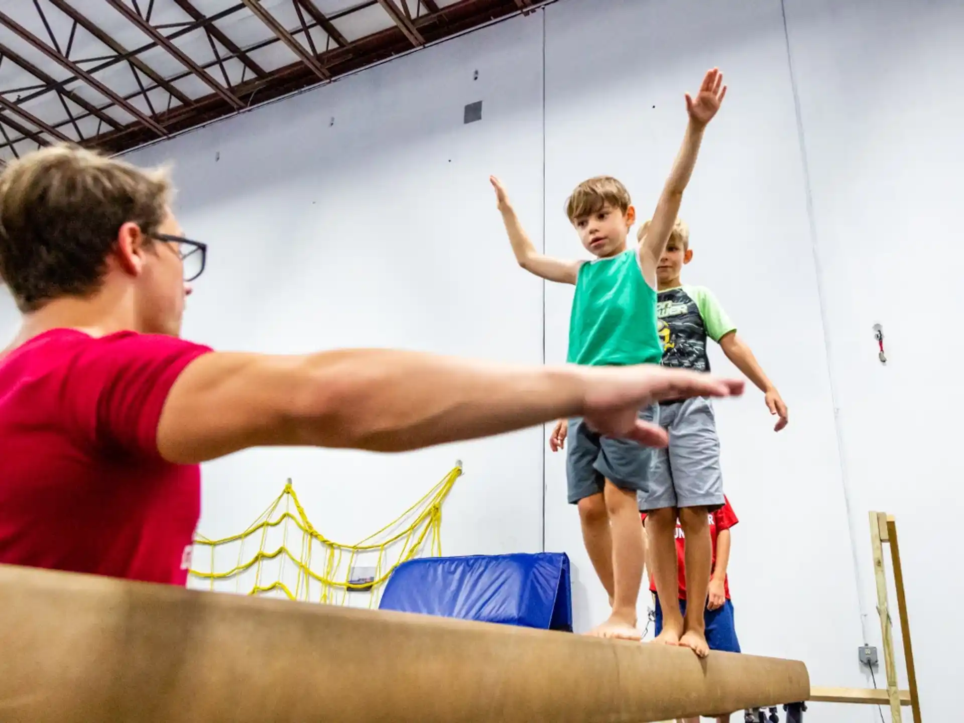 a man holding a child on a trampoline