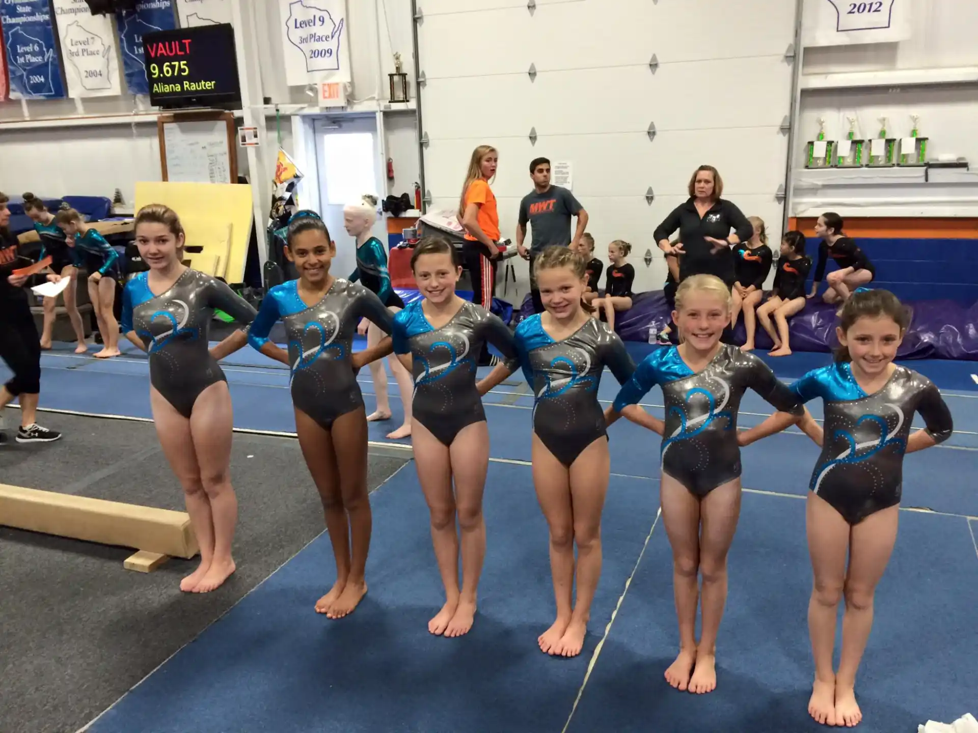 a group of girls in swimsuits posing for a photo