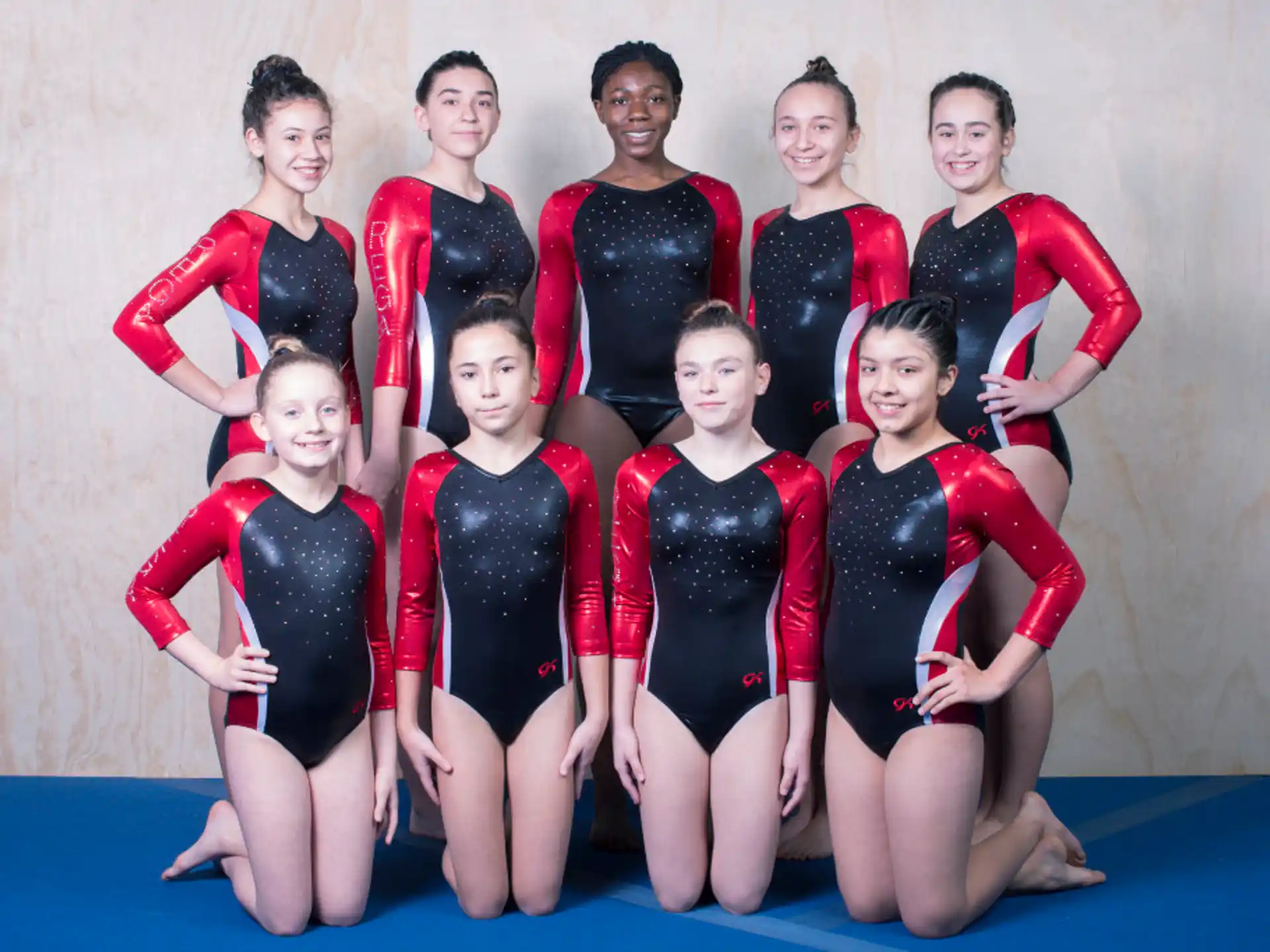 a group of women in leotards posing for a photo