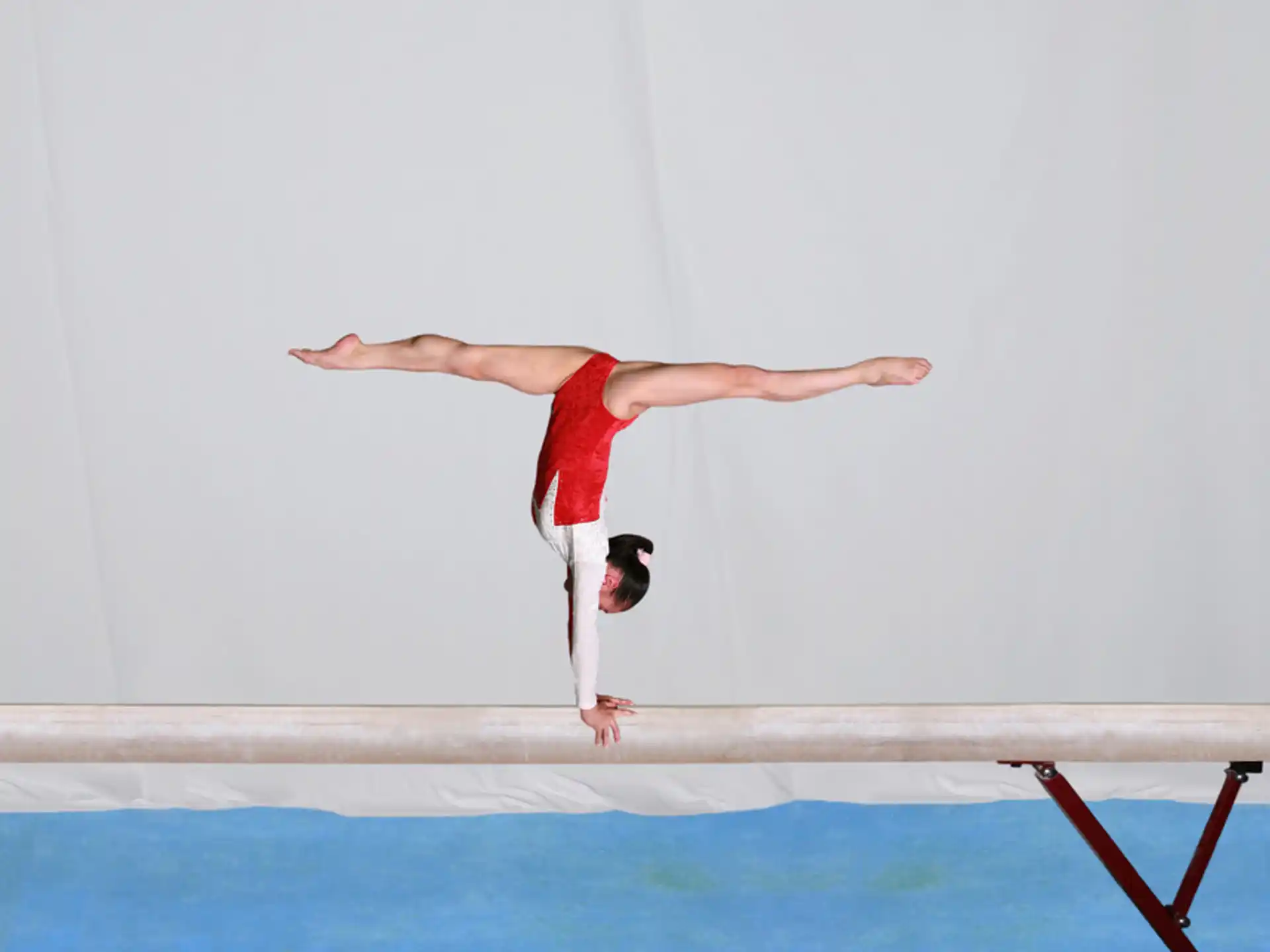 a person doing a handstand on a table