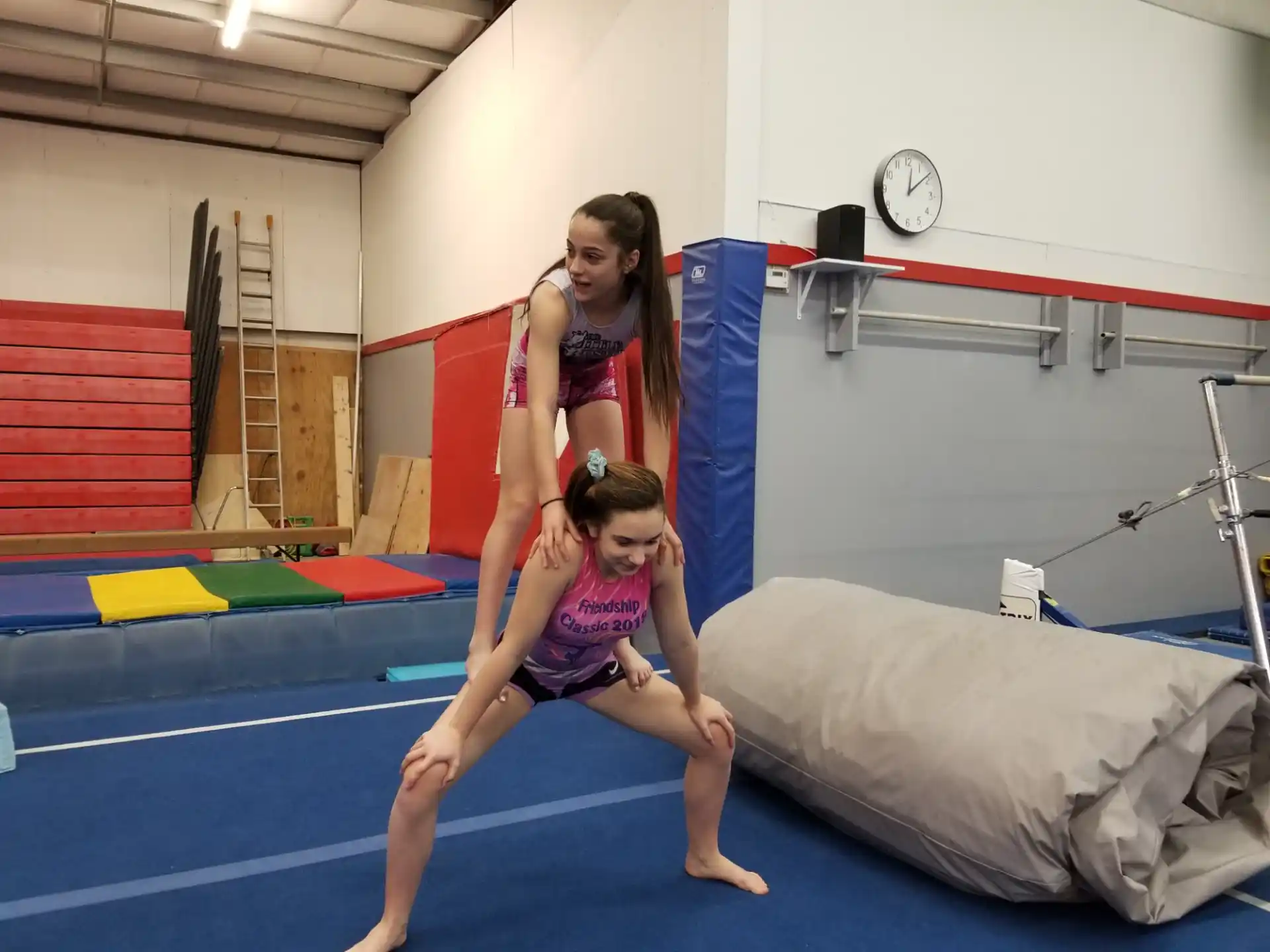 a woman and a girl in a gym