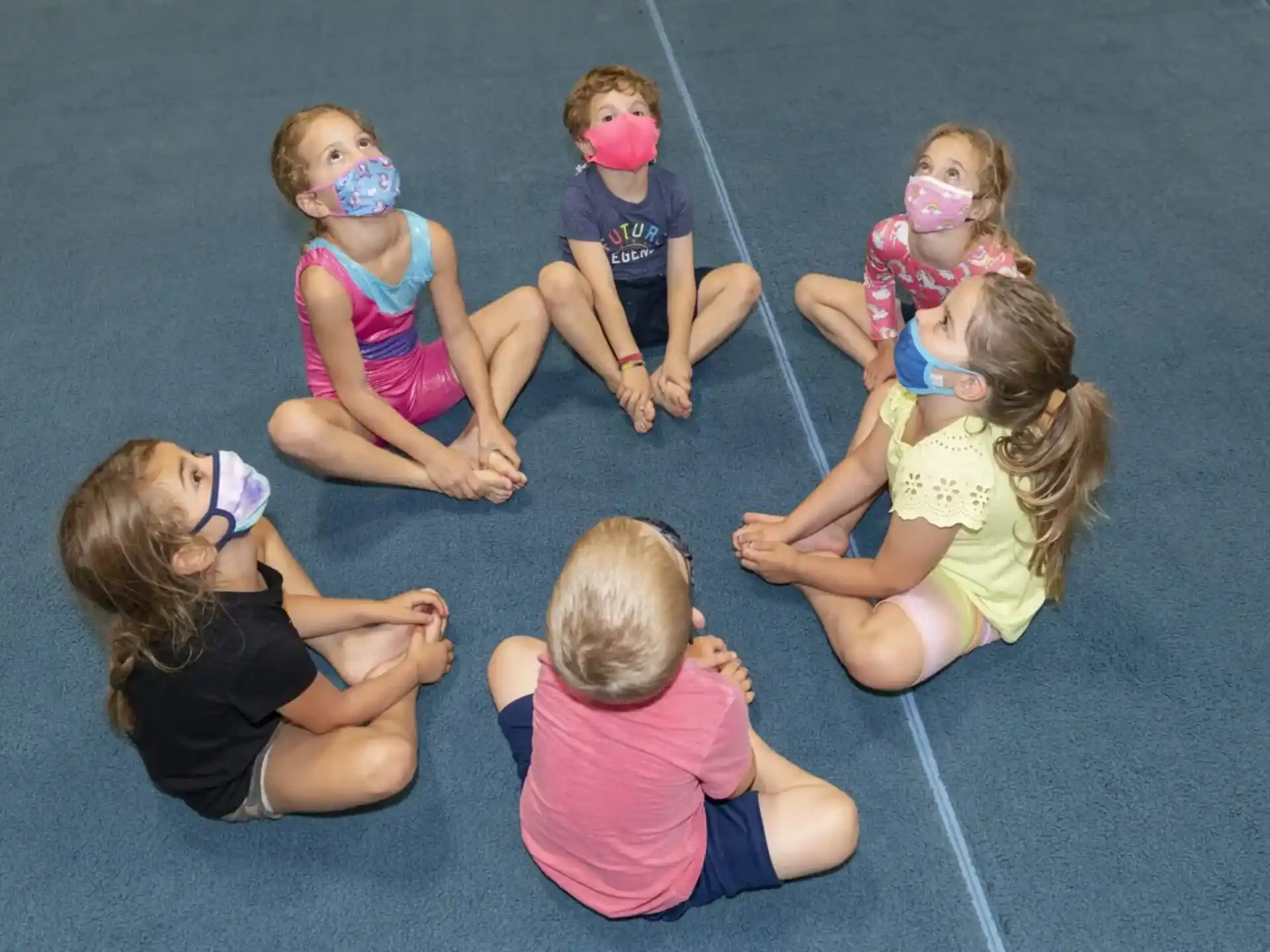 a group of children sitting on the ground