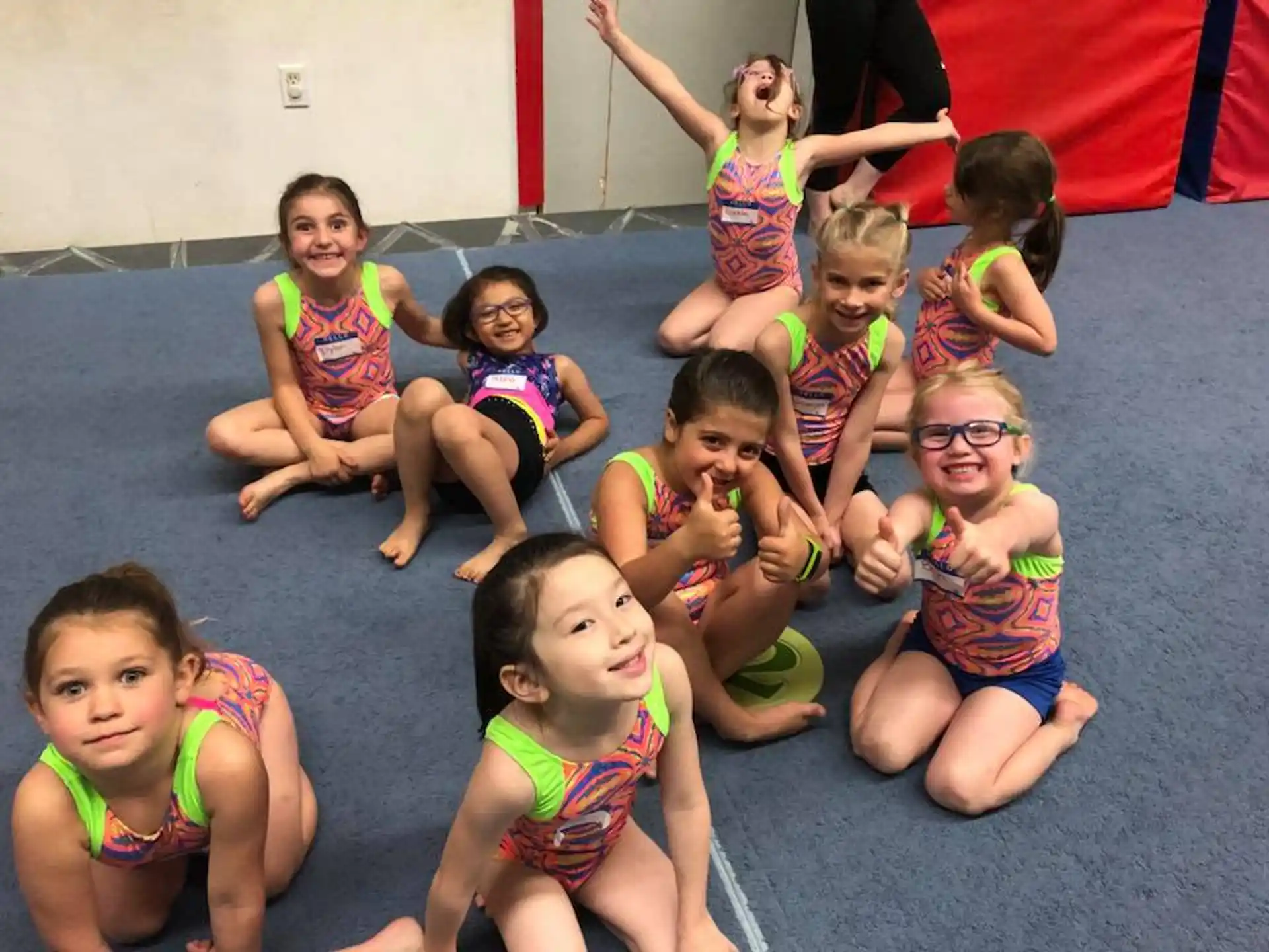 a group of children in colorful swimsuits