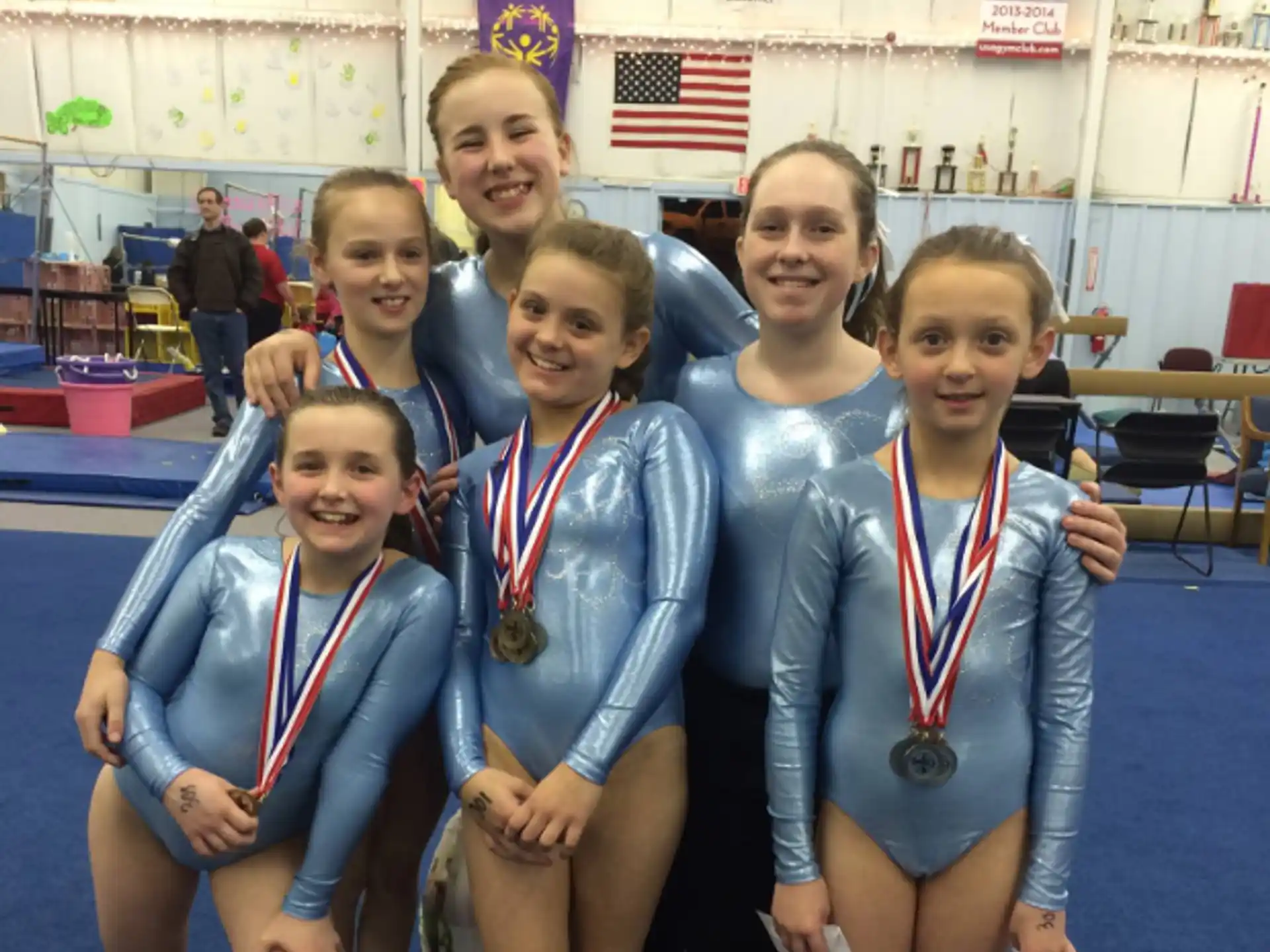 a group of girls wearing medals