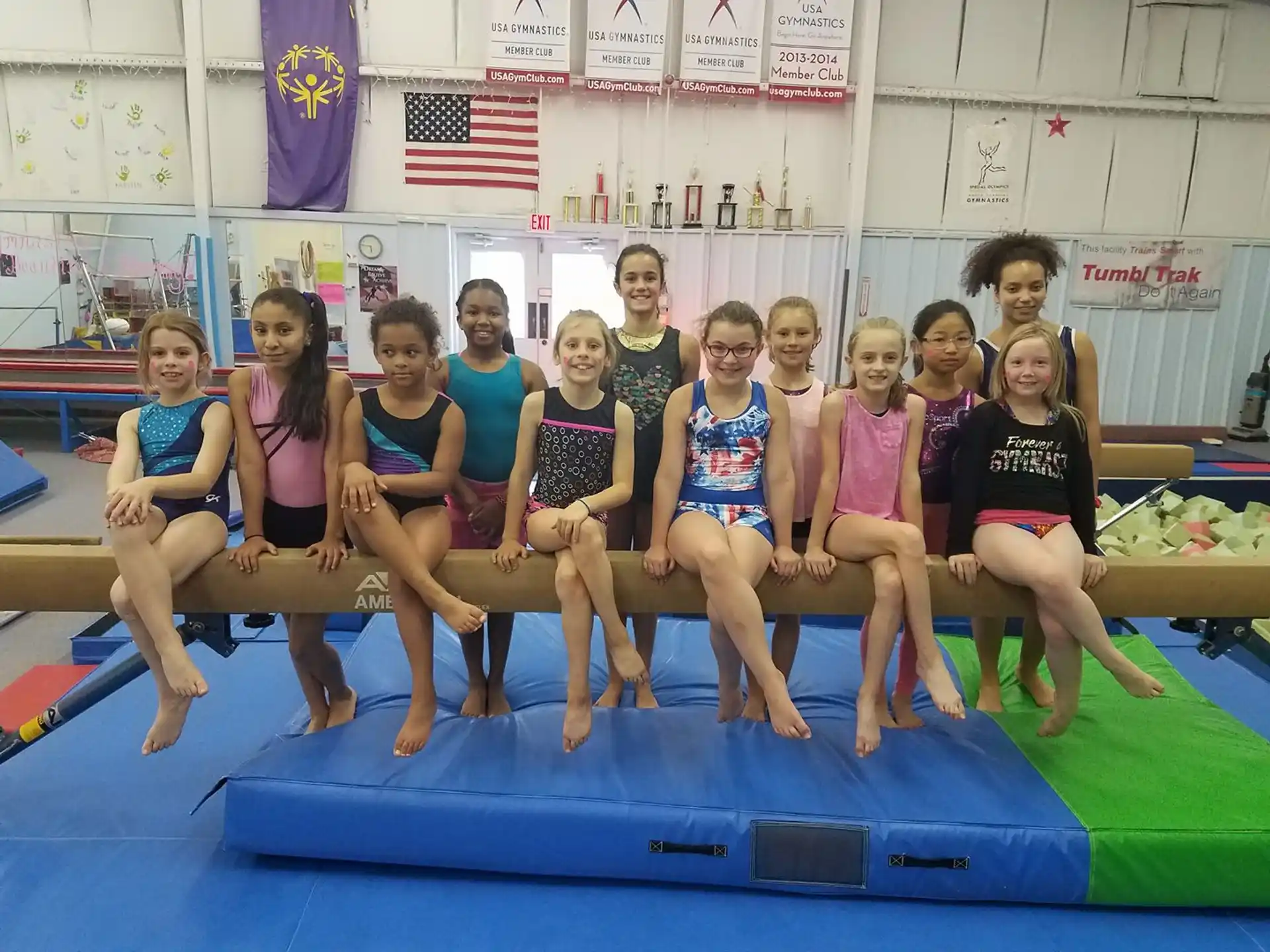 a group of women posing for a photo on a mat