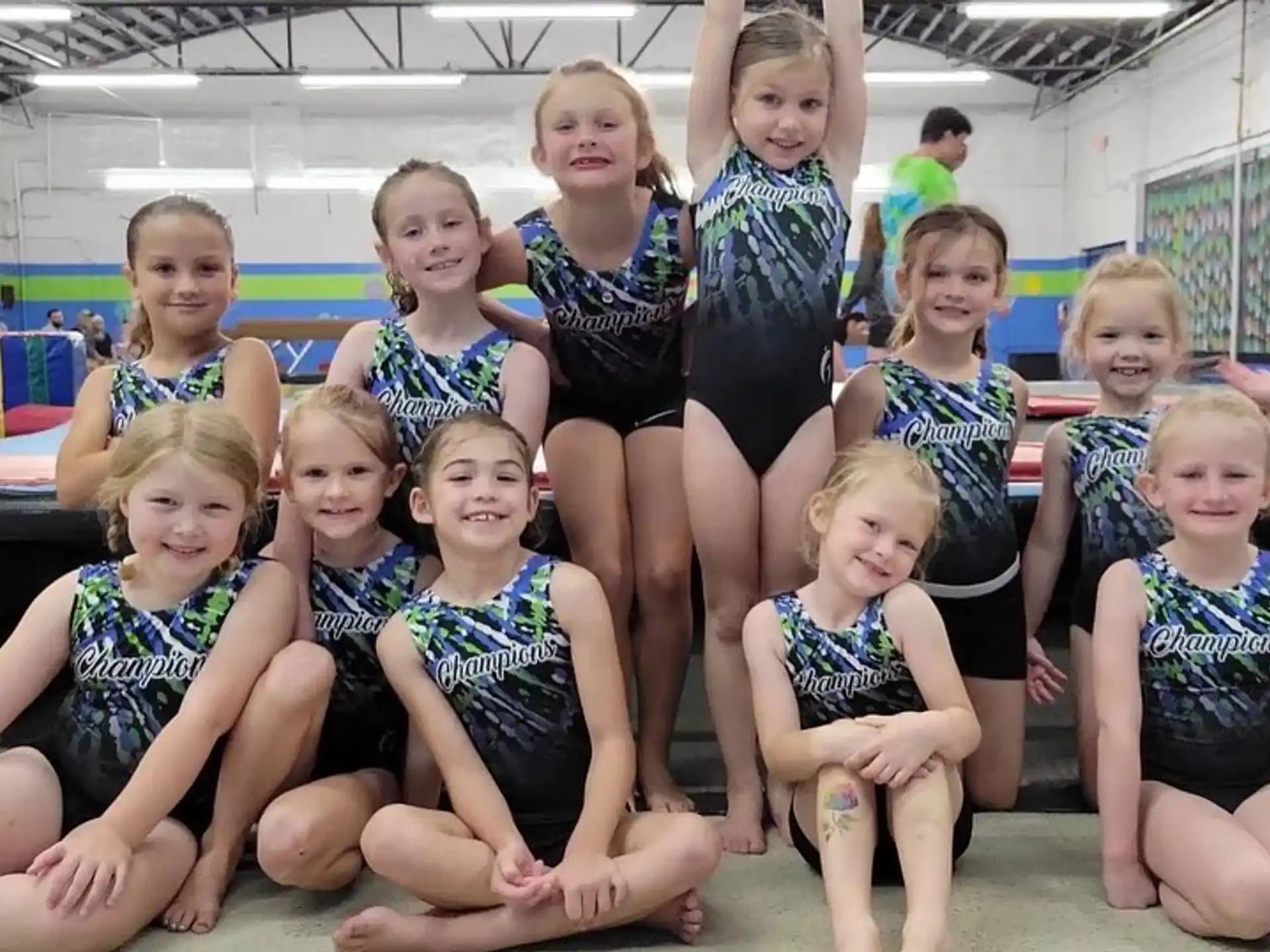 a group of girls in swimsuits posing for a photo