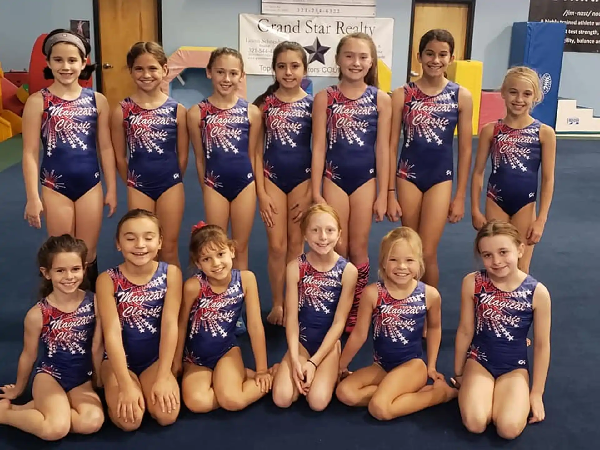 a group of girls in swimsuits posing for a photo